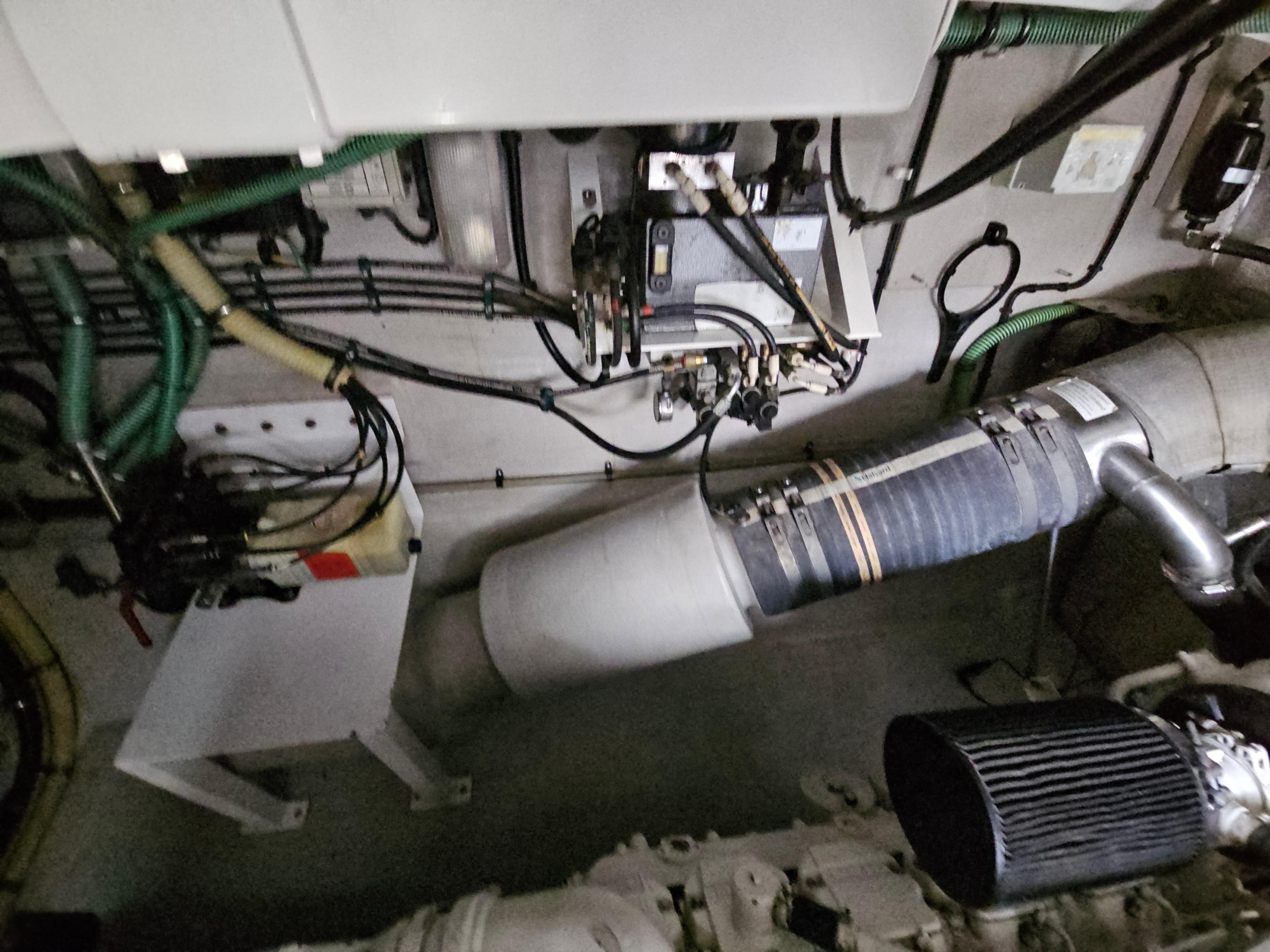 Engine room of 2010 Sunseeker Predator 64 yacht, showcasing mechanical components and wiring.