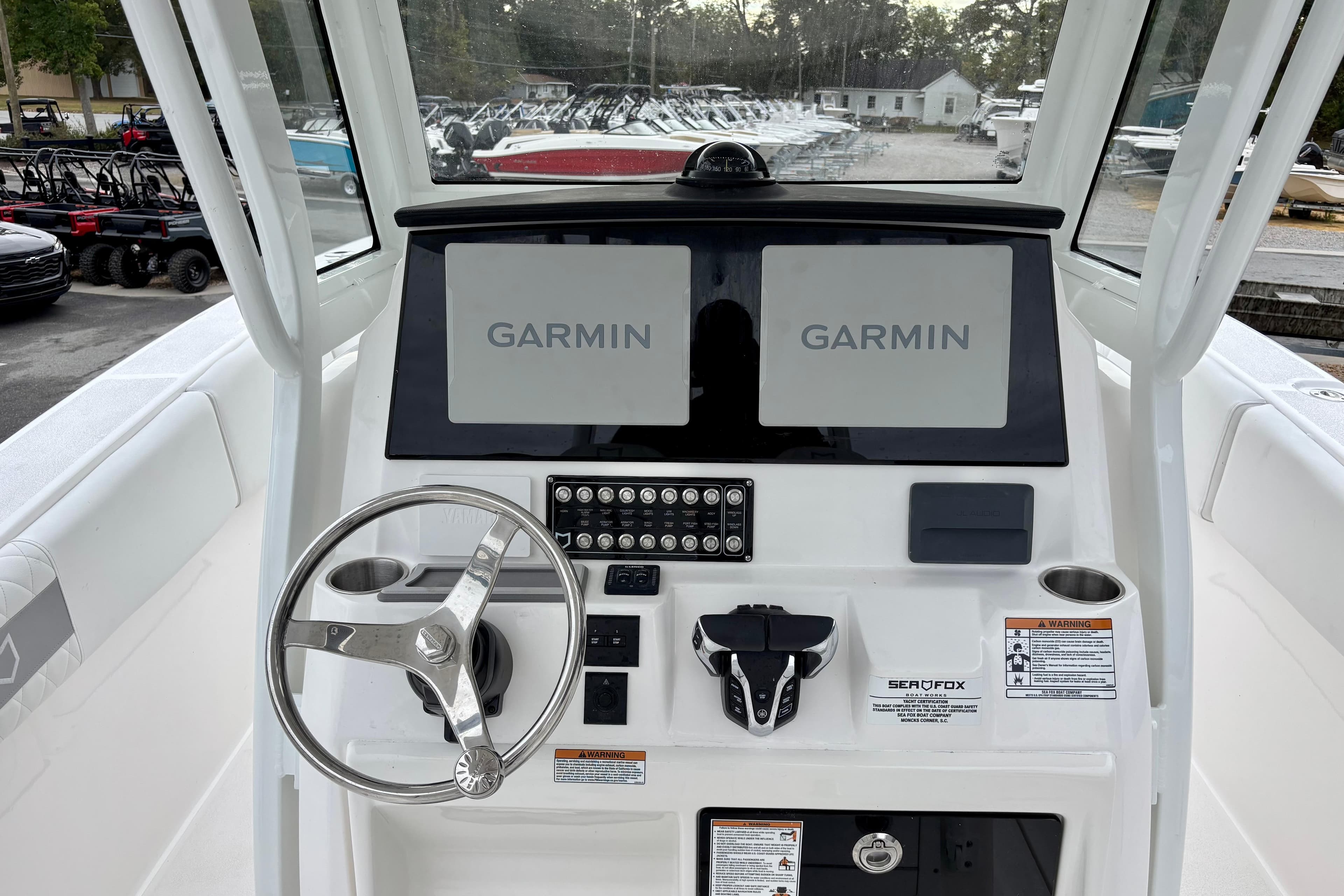 2026 Sea Fox 288 Commander helm with dual Garmin displays and steering wheel.