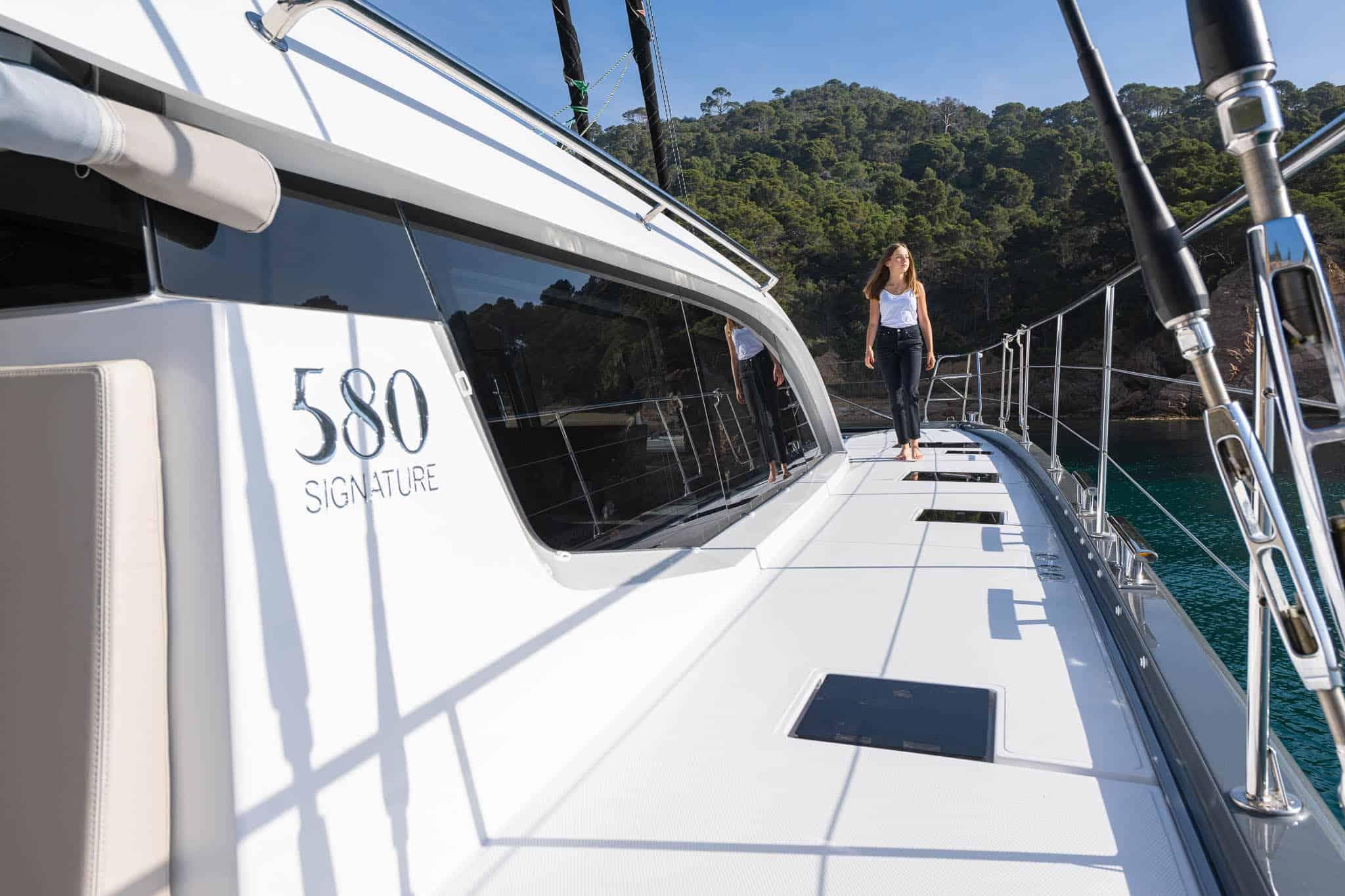 Luxury Privilege Signature 580 yacht, 2025 model, with person walking on deck.