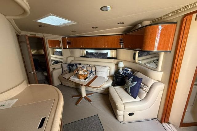Luxurious interior of 2000 Sea Ray Sundancer 460 yacht with plush seating and elegant decor.