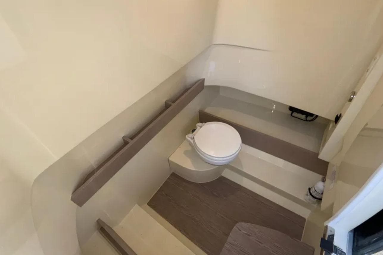 2024 Capoforte FX270 boat interior bathroom with modern design and compact toilet.