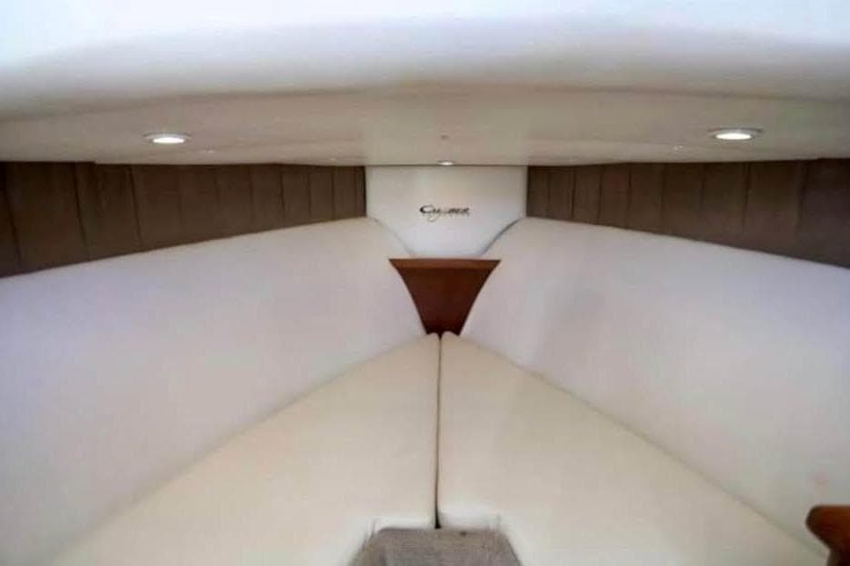 Interior cabin of 2006 Calyber 29 Express boat with cushioned seating.
