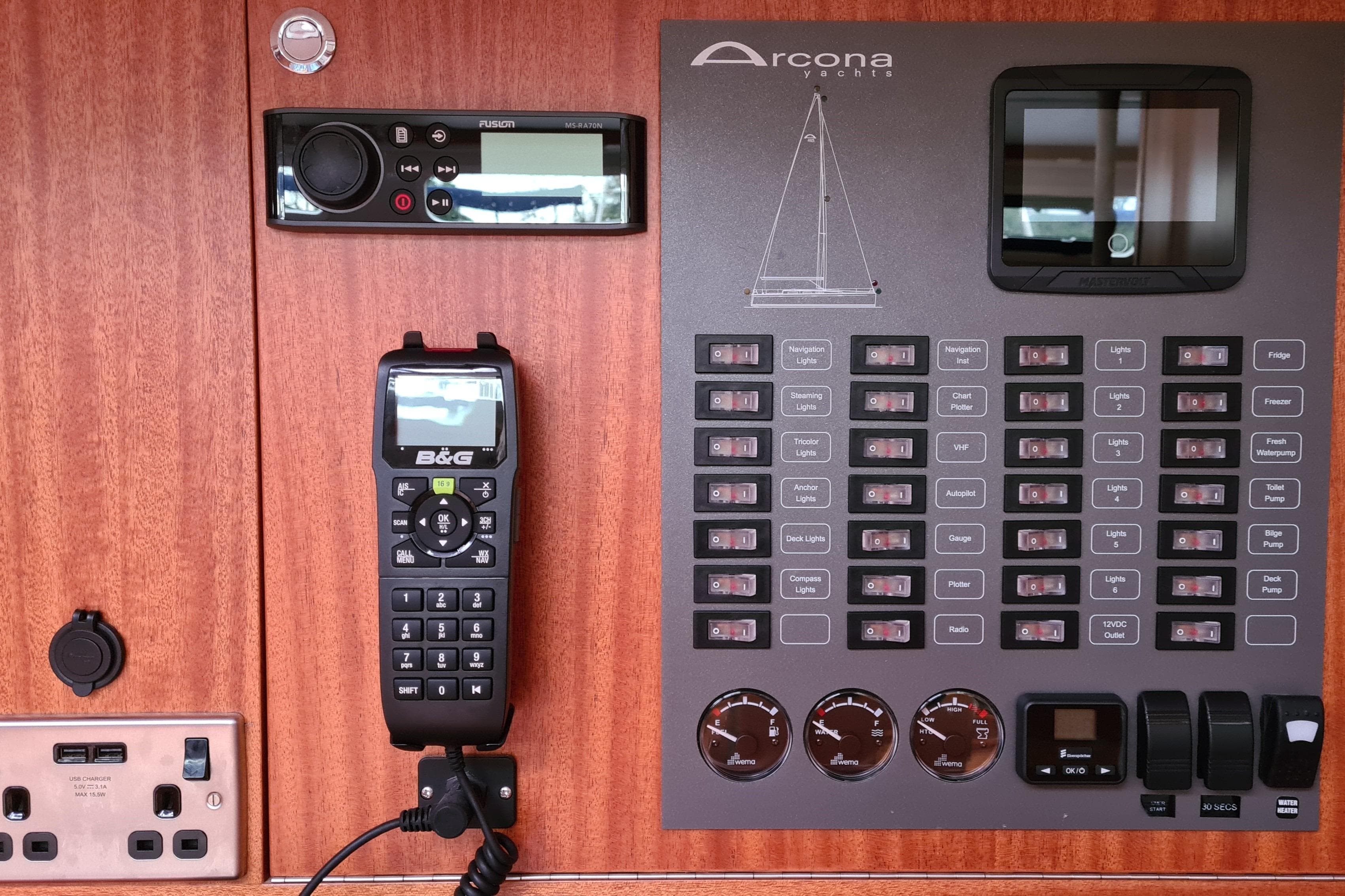 Control panel of 2018 Arcona 435 yacht with switches and communication devices.
