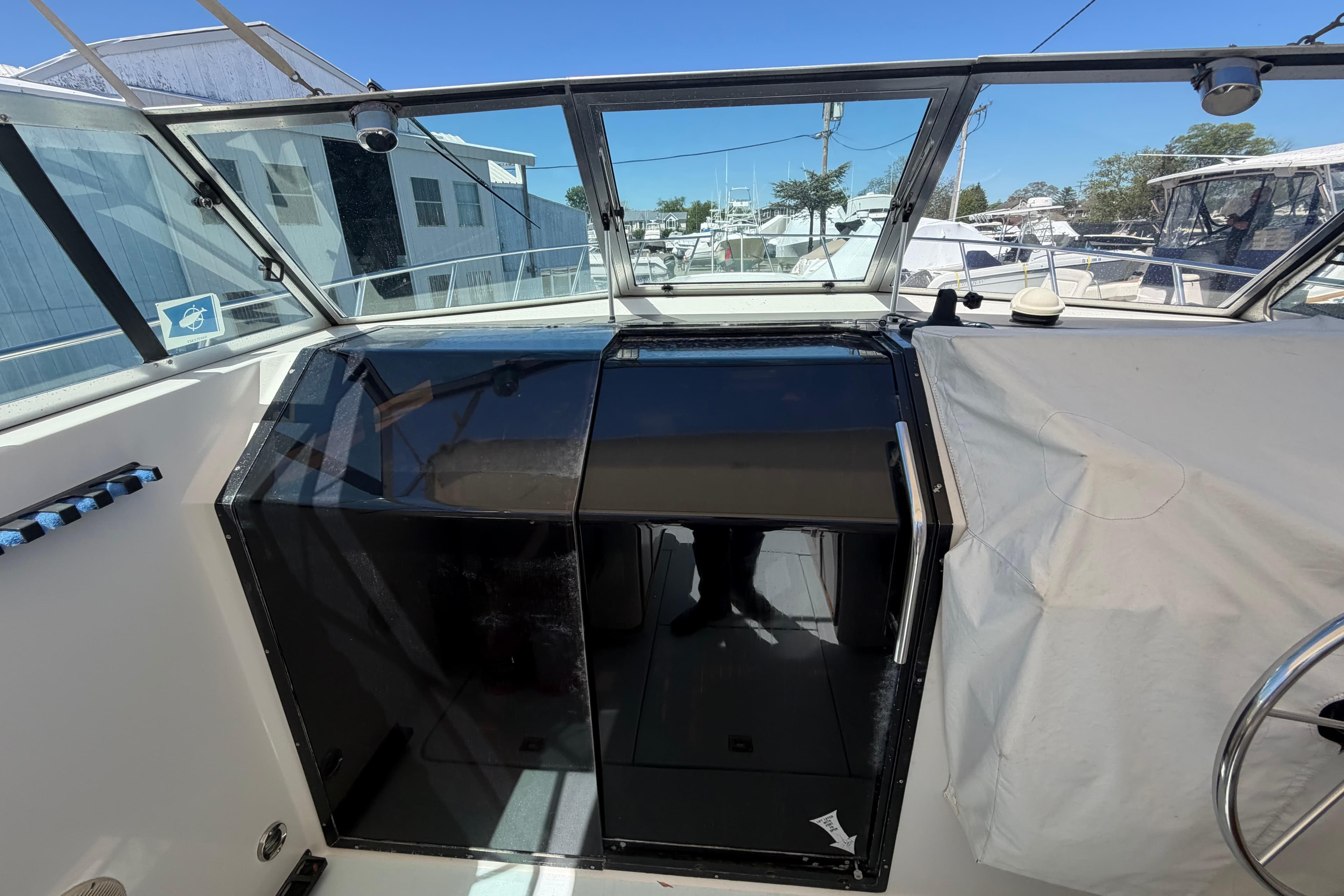 1985 Formula 31 Performance Cruiser cockpit with glass doors and marina view.