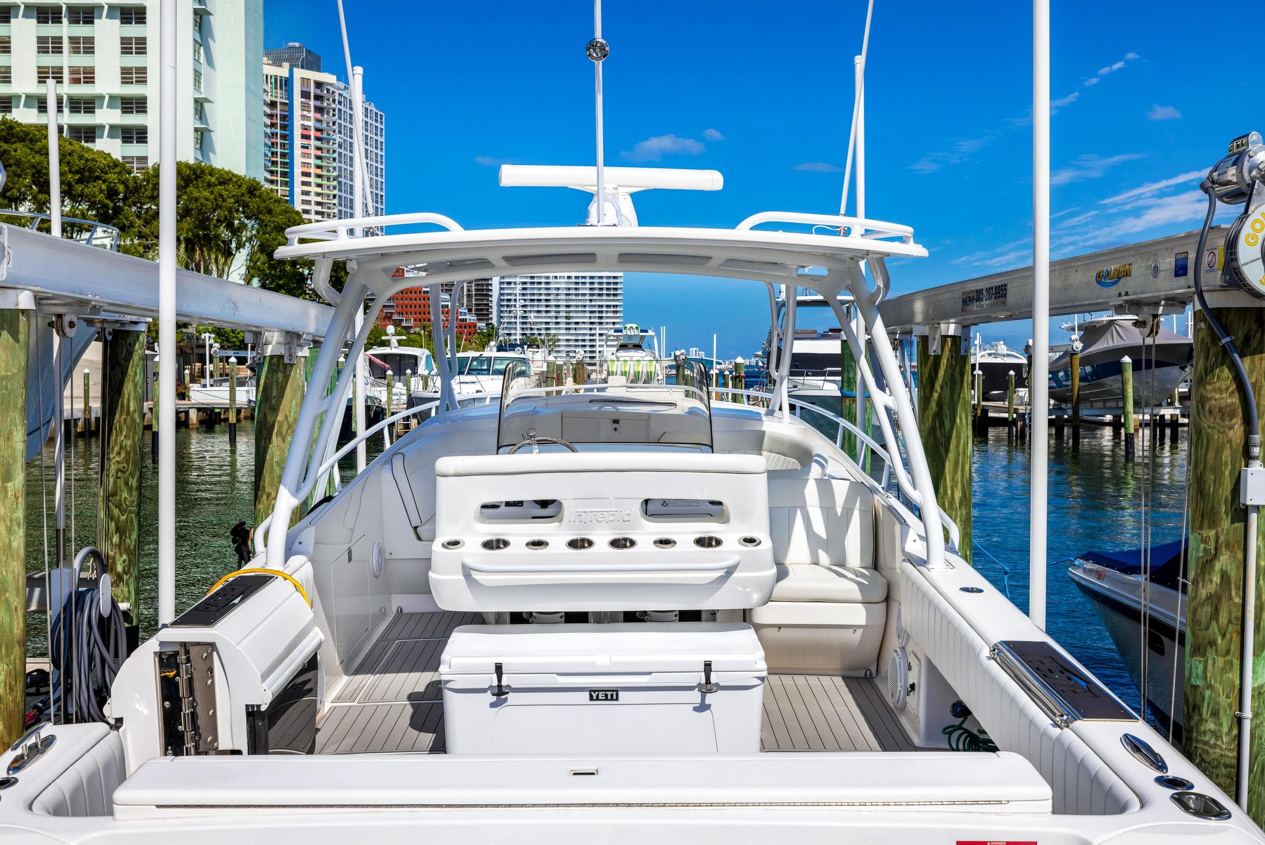 2016 Intrepid 400 Cuddy boat docked at a marina with cityscape background.