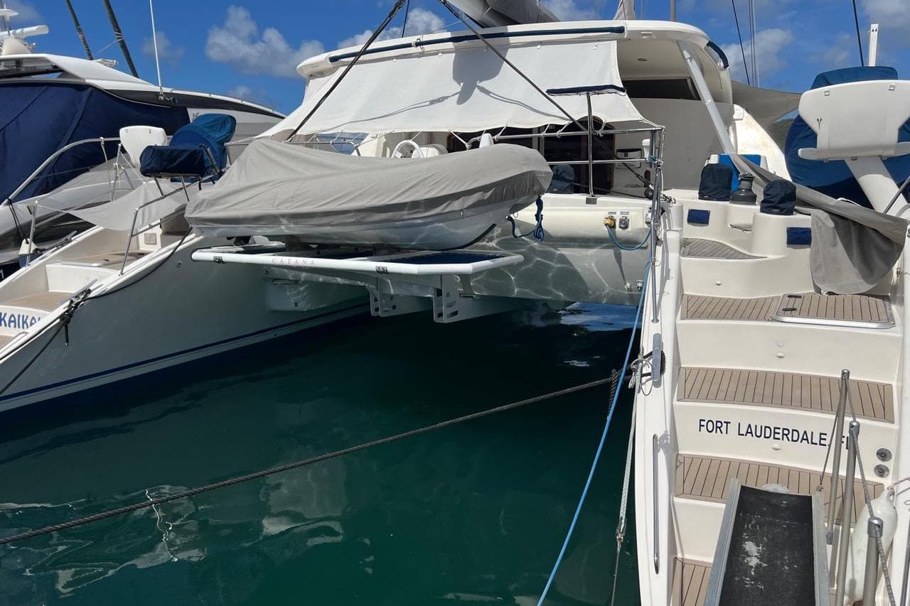 2003 Catana 582 yacht docked in Fort Lauderdale marina, featuring covered dinghy.