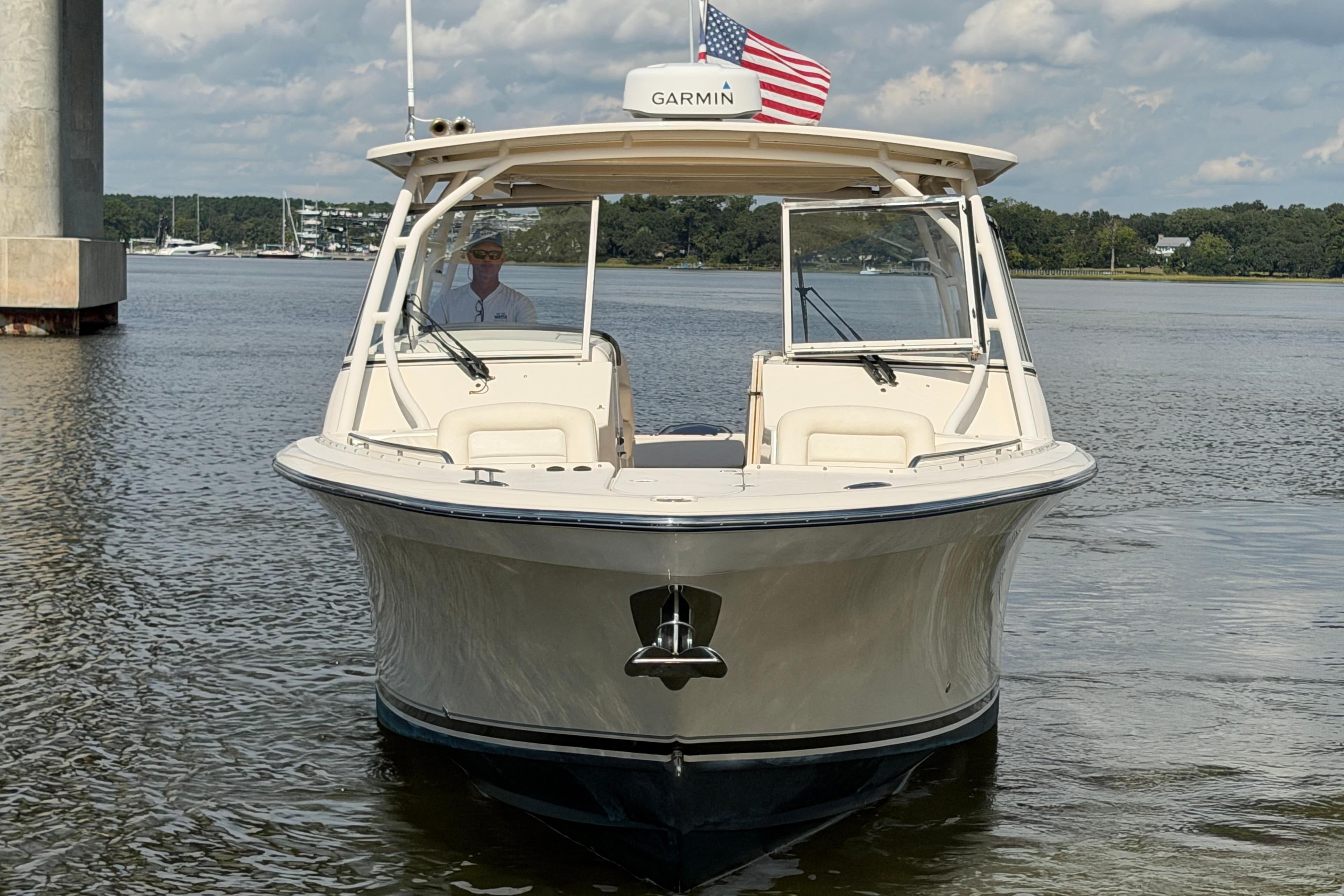 2017 Grady-White Freedom 335 boat on calm water, American flag displayed.