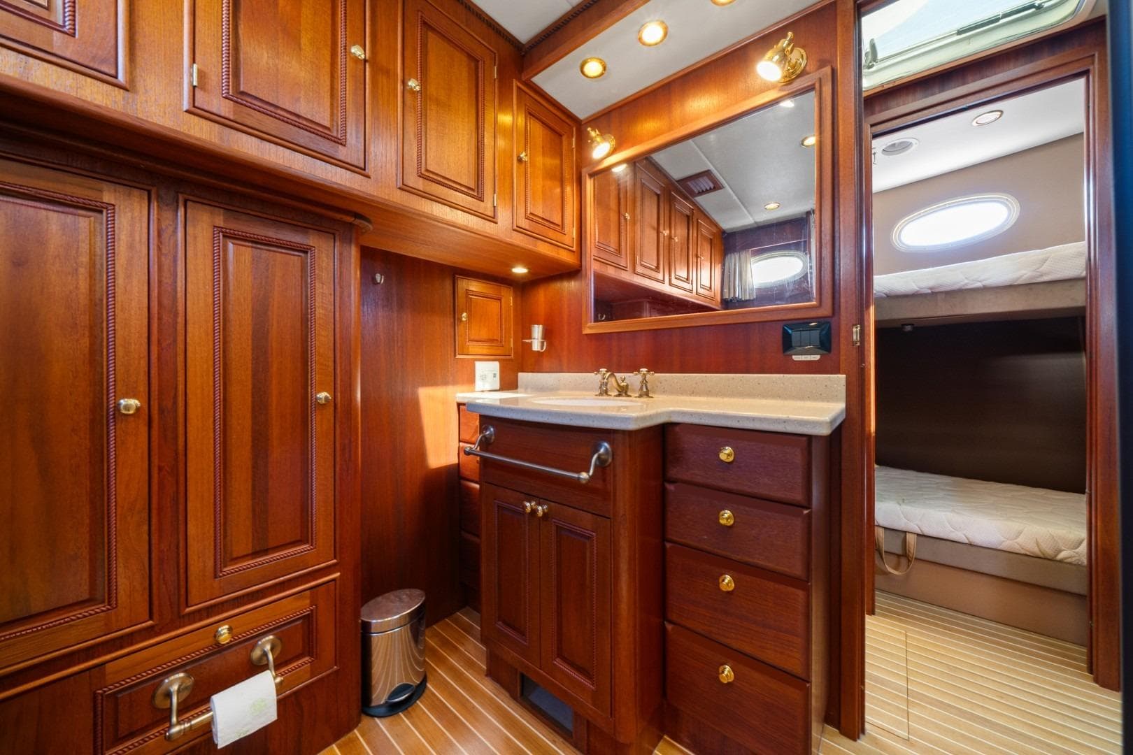 Luxurious wooden interior of 2009 EagleCraft 47' Pilothouse yacht bathroom and cabin.