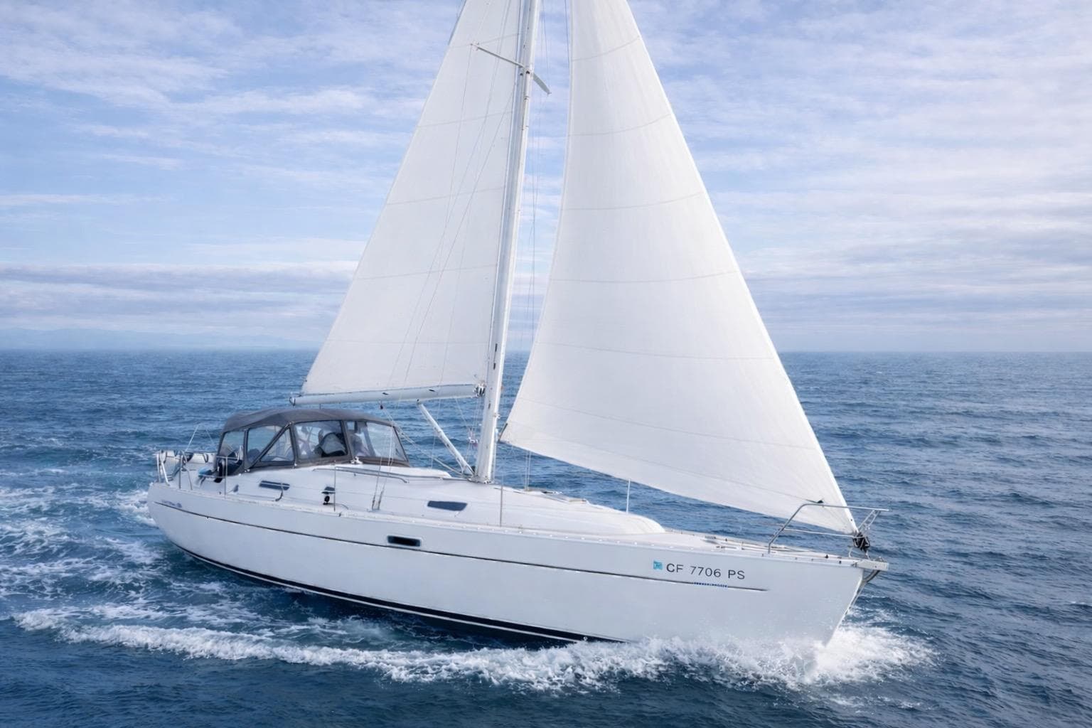 Sailing yacht Beneteau 331, 2001 model, cruising on open sea with full sails.