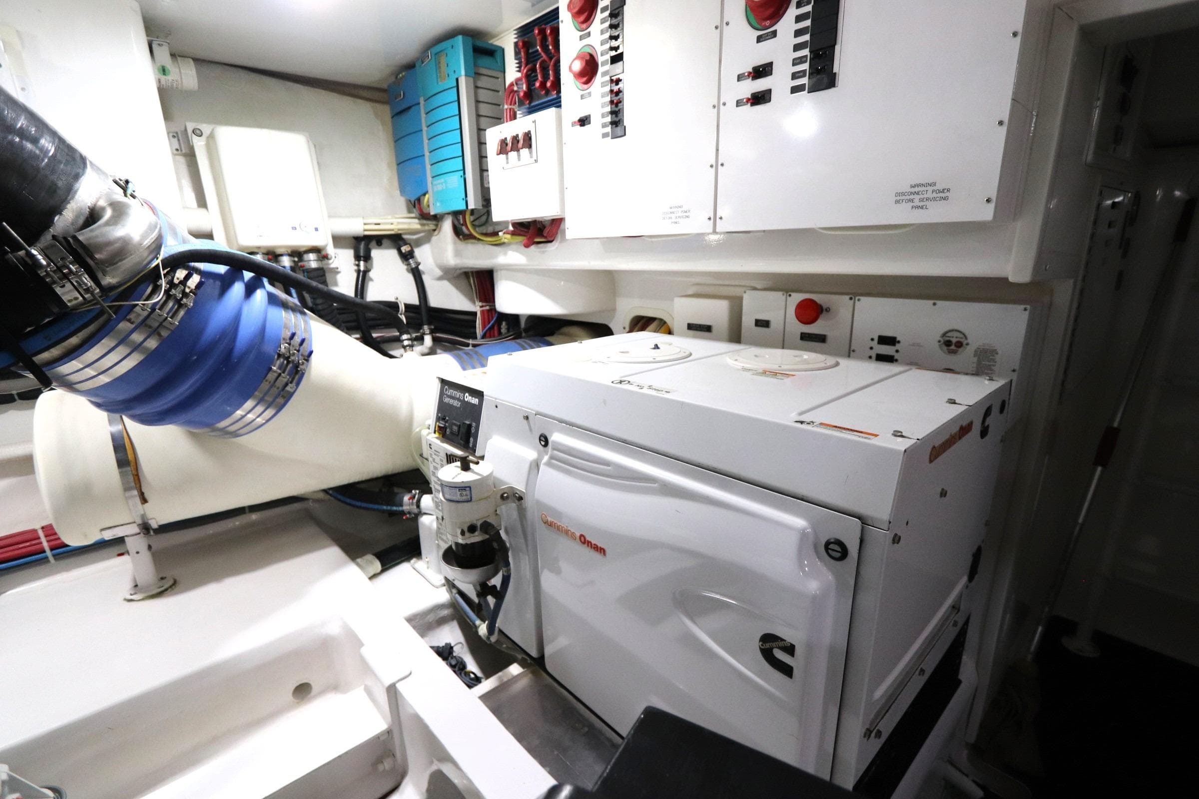 Engine room of 2013 Viking 66 yacht with Cummins Onan generator and control panels.
