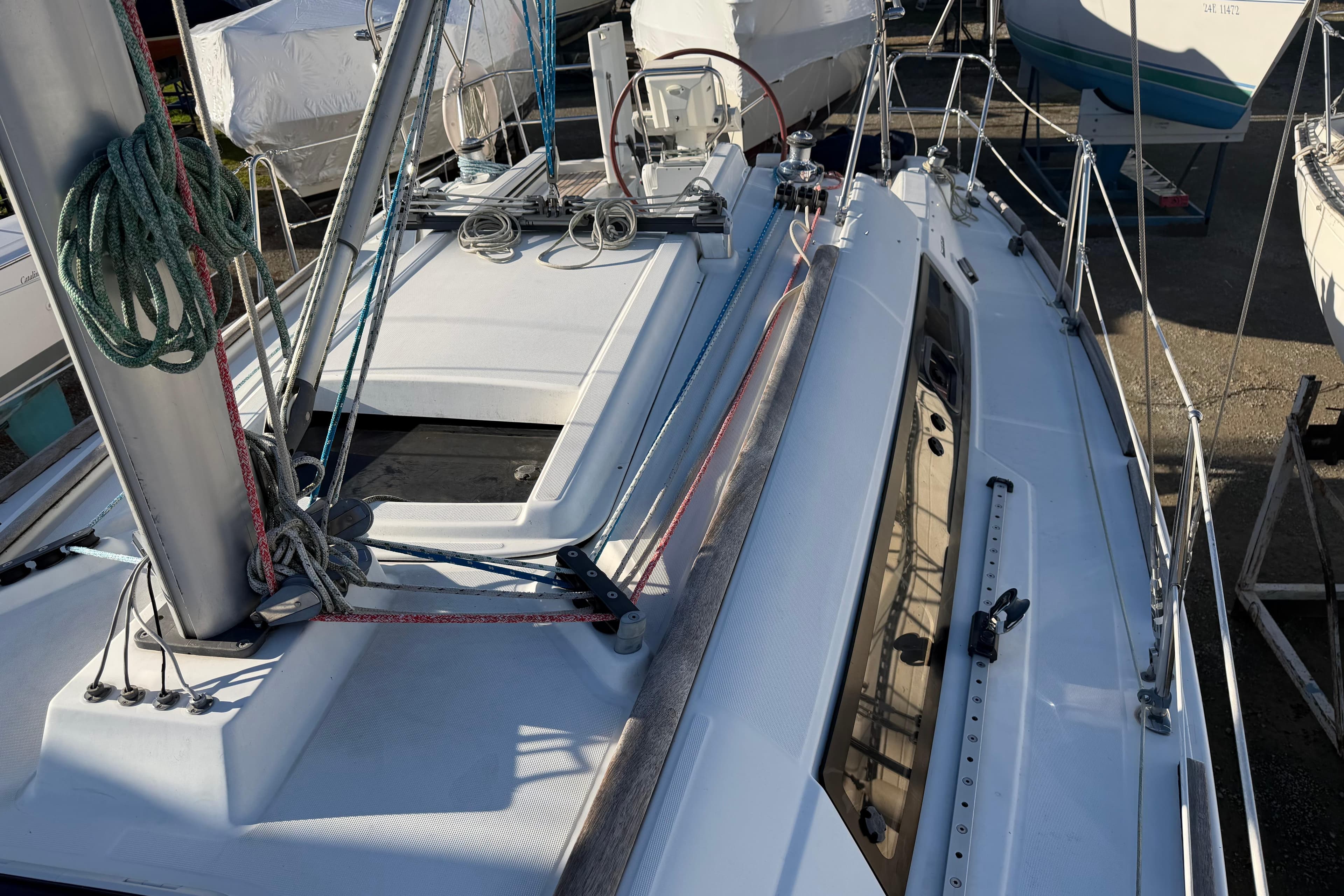 2008 Beneteau 31 sailboat deck with rigging and ropes in marina.