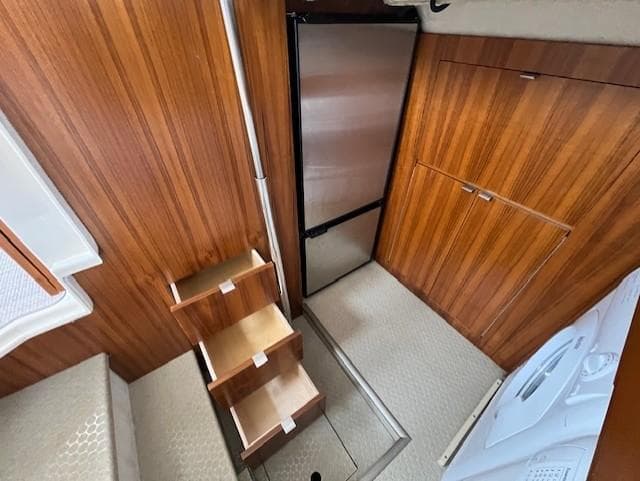 Interior of 2019 Ranger Tugs R-41 CB with wooden cabinetry and compact stairs.