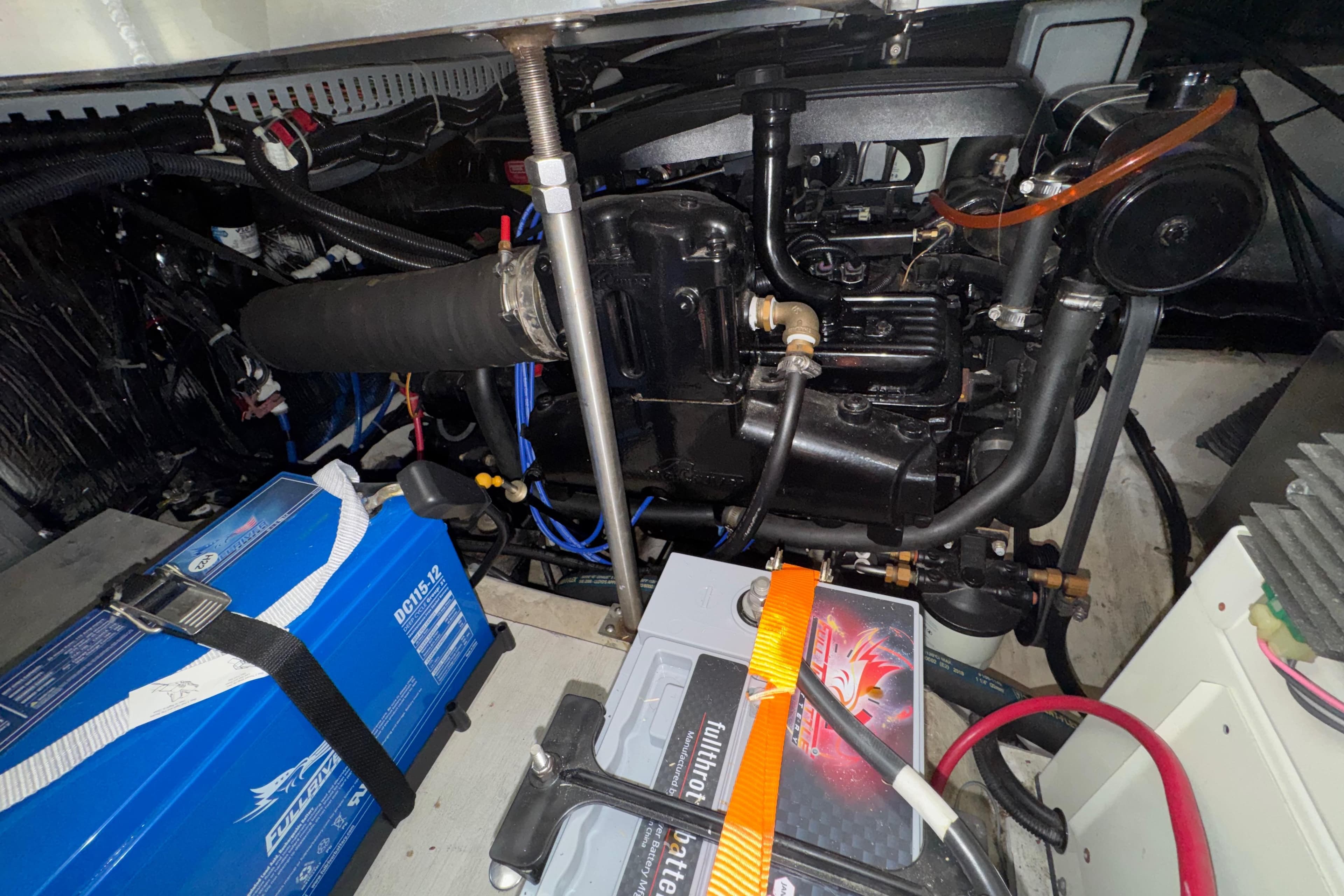 Engine compartment of a 2001 Carver 356 Motor Yacht with visible batteries and components.