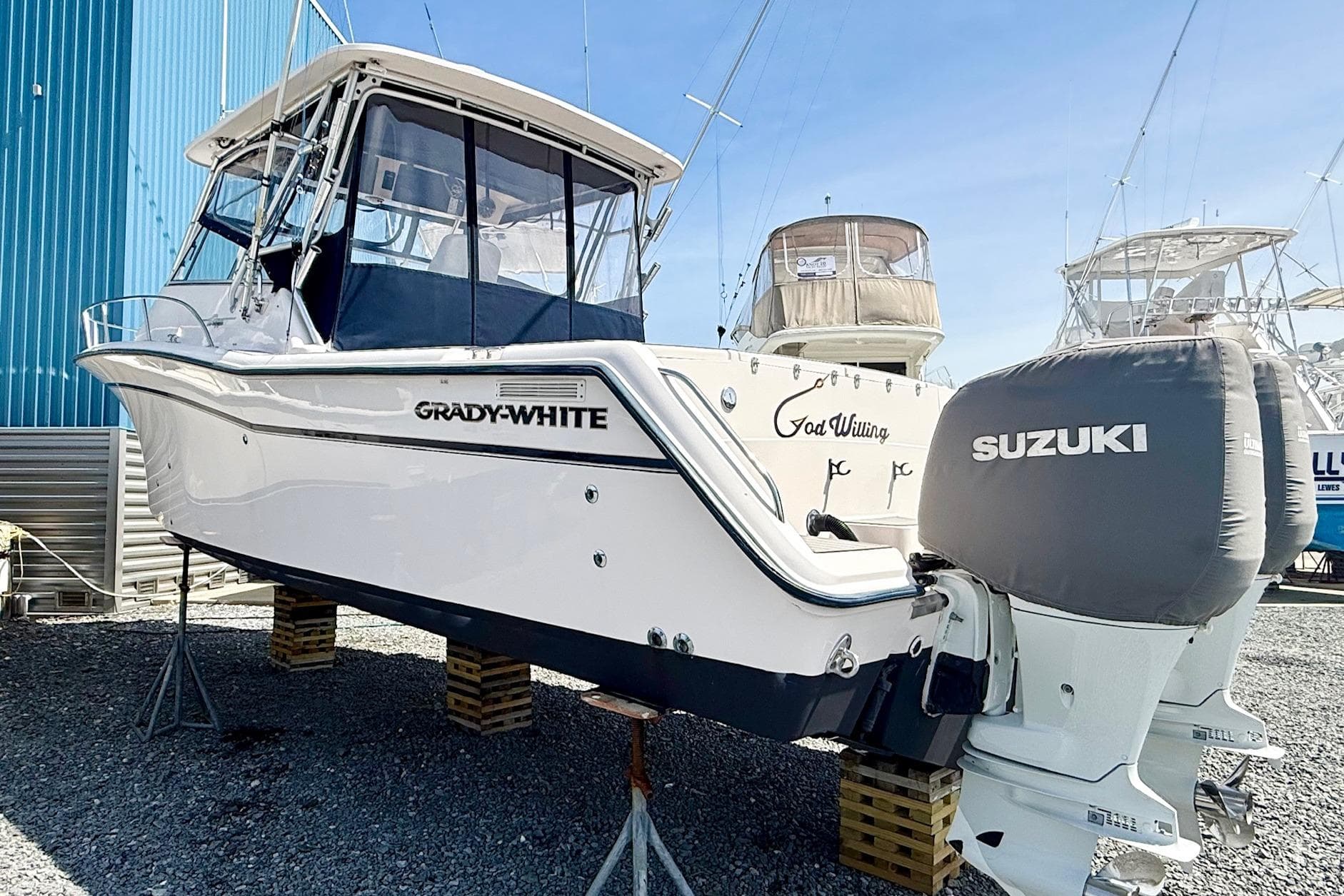 2002 Grady-White Express 330 boat with Suzuki engines on display.