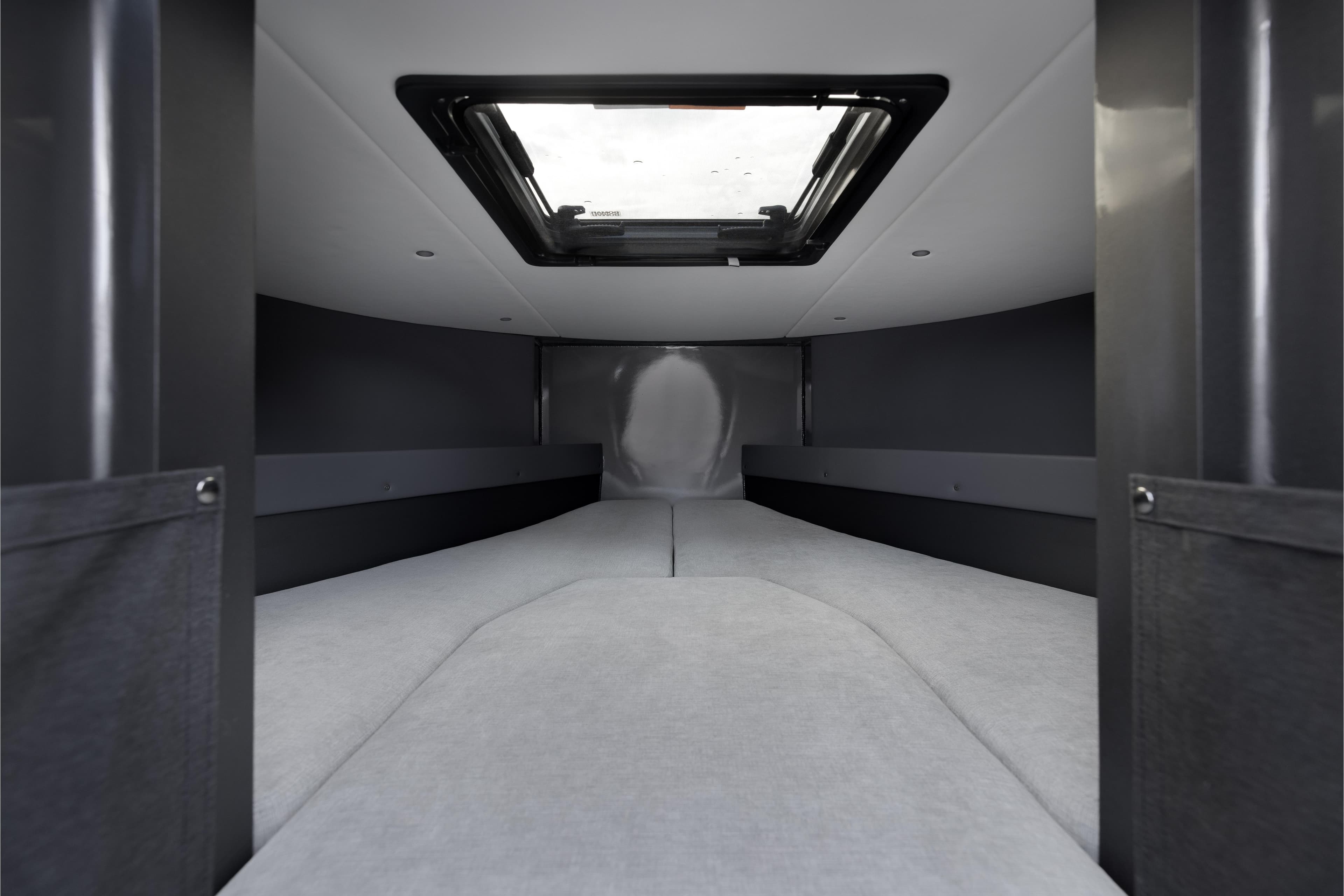 Interior cabin of 2026 Jasper Marine Defender 22, featuring a skylight and modern design.