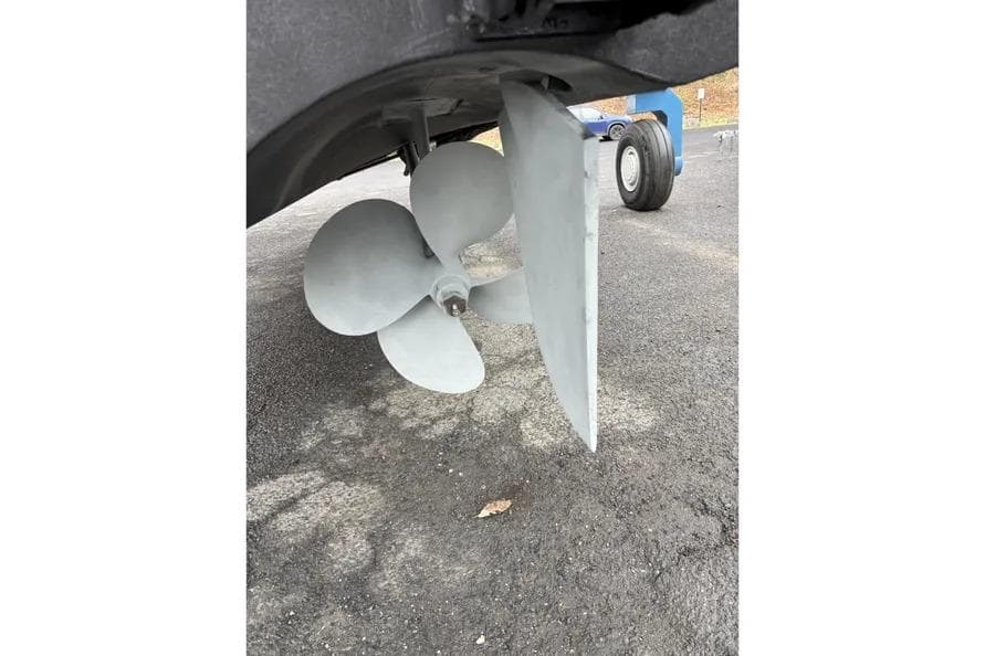 Propeller and rudder of a 2014 Azimut 45 yacht on dry land.
