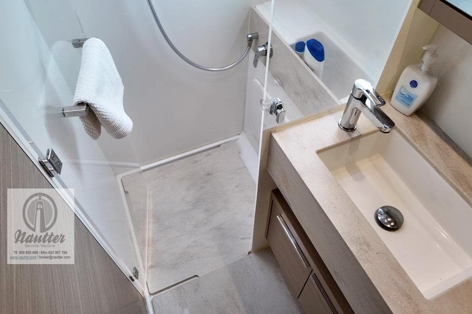 Modern bathroom in 2023 Lagoon 46 yacht, featuring sleek sink and shower design.