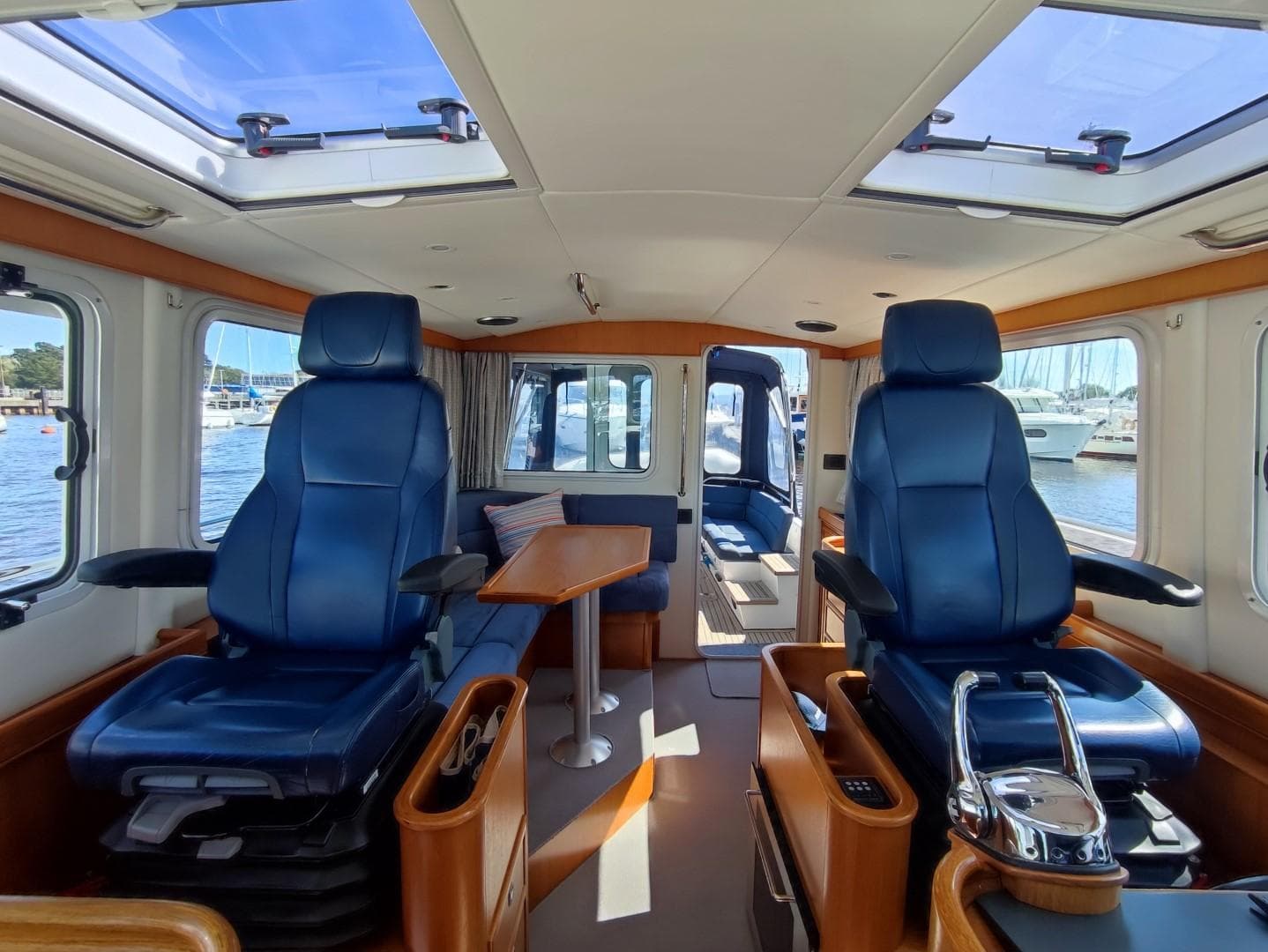 Interior of 2016 Seaward MY-42 yacht with blue seating and wooden accents.