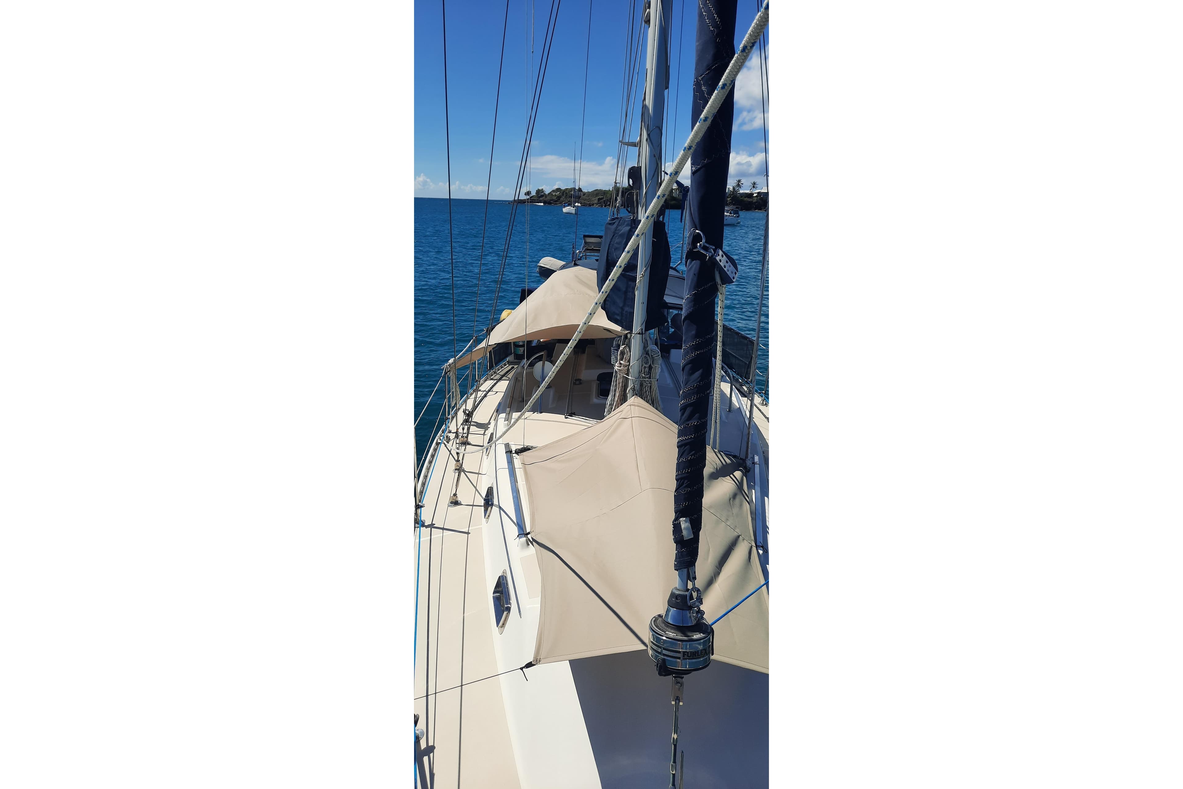 2005 Caliber 40LRC SE sailboat on calm blue waters, showcasing deck and rigging.