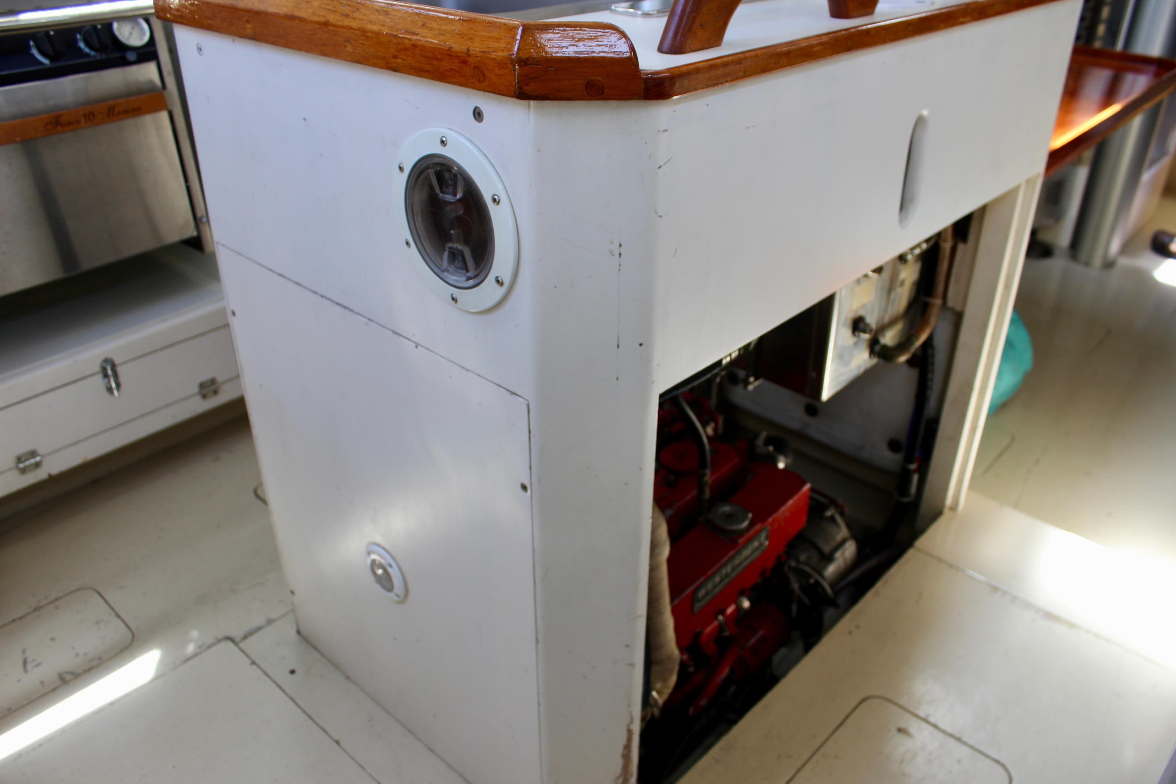 Engine compartment of a 1993 Freya 39 sailboat, featuring a visible red engine.