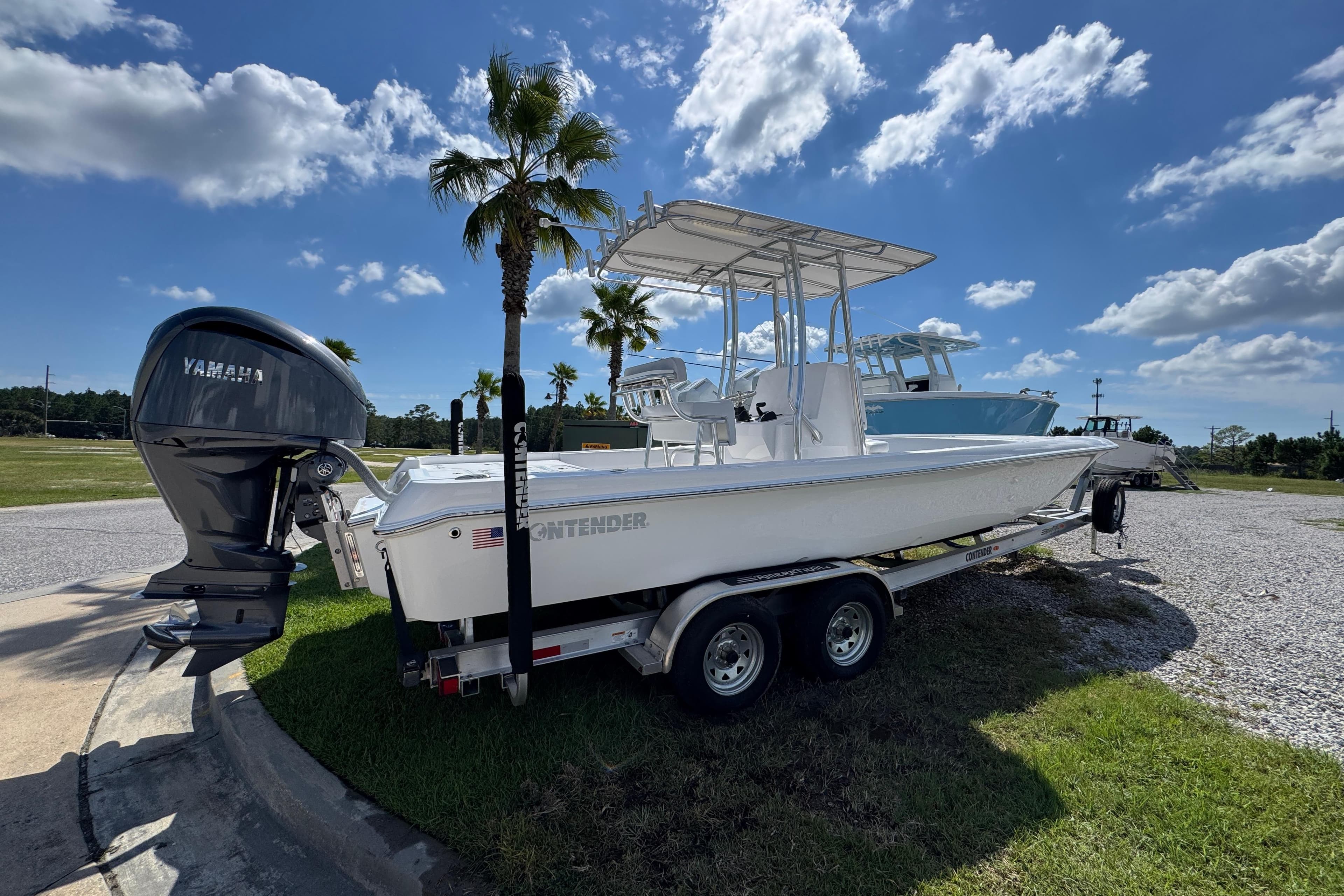 2026 Contender 26 Bay boat on trailer with Yamaha engine, parked under blue sky.
