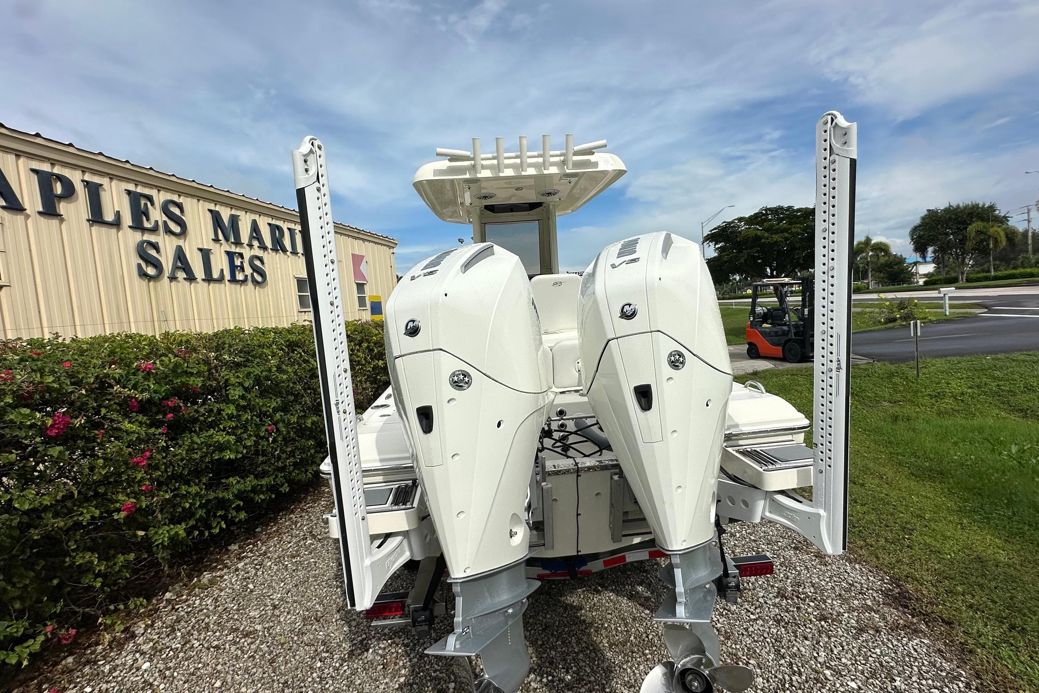 2026 ShearWater 270 SS Open boat with dual engines at a marine sales location.