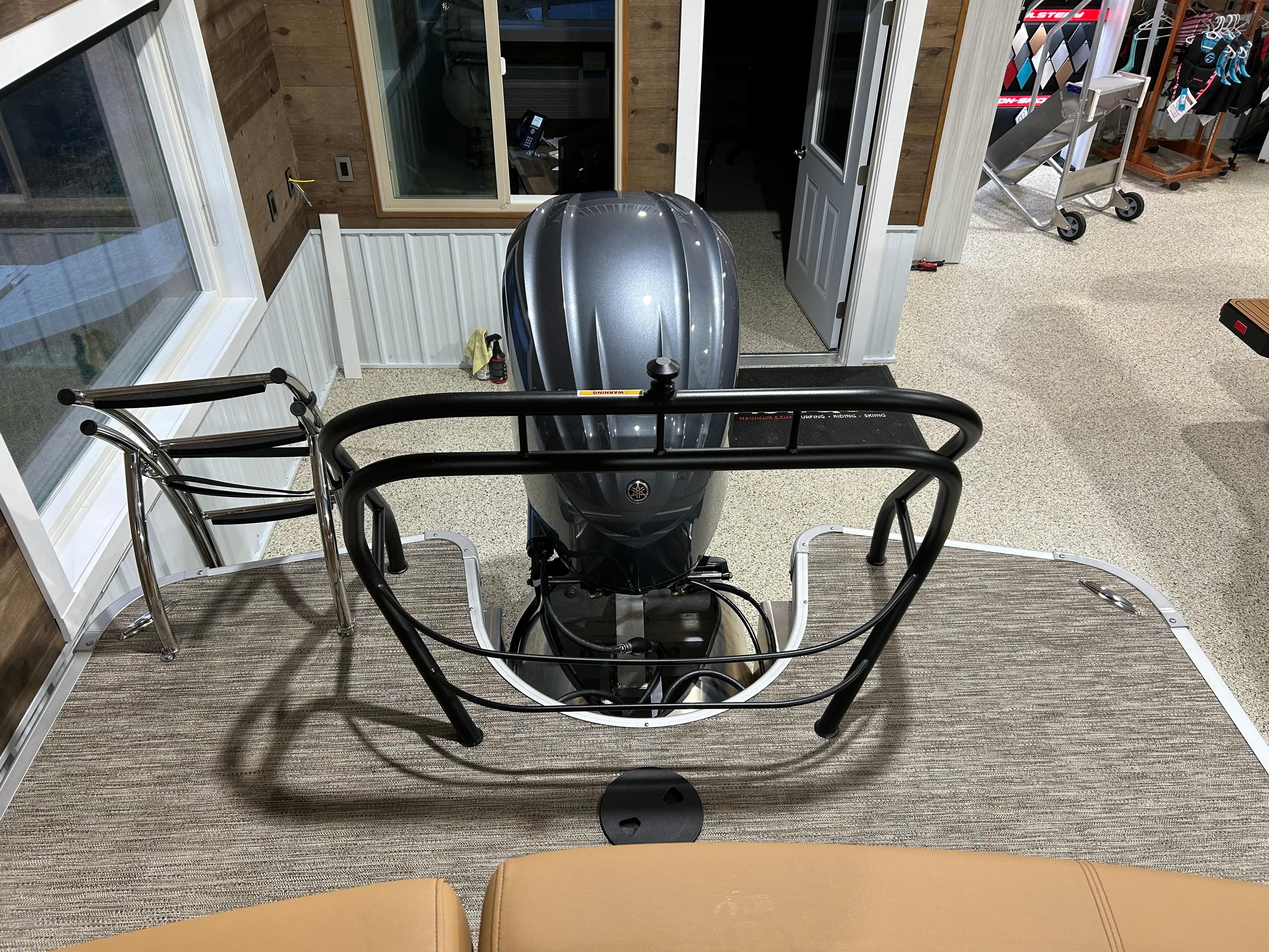 2025 Godfrey Aqua Patio 235 ULC boat interior with motor and seating area.