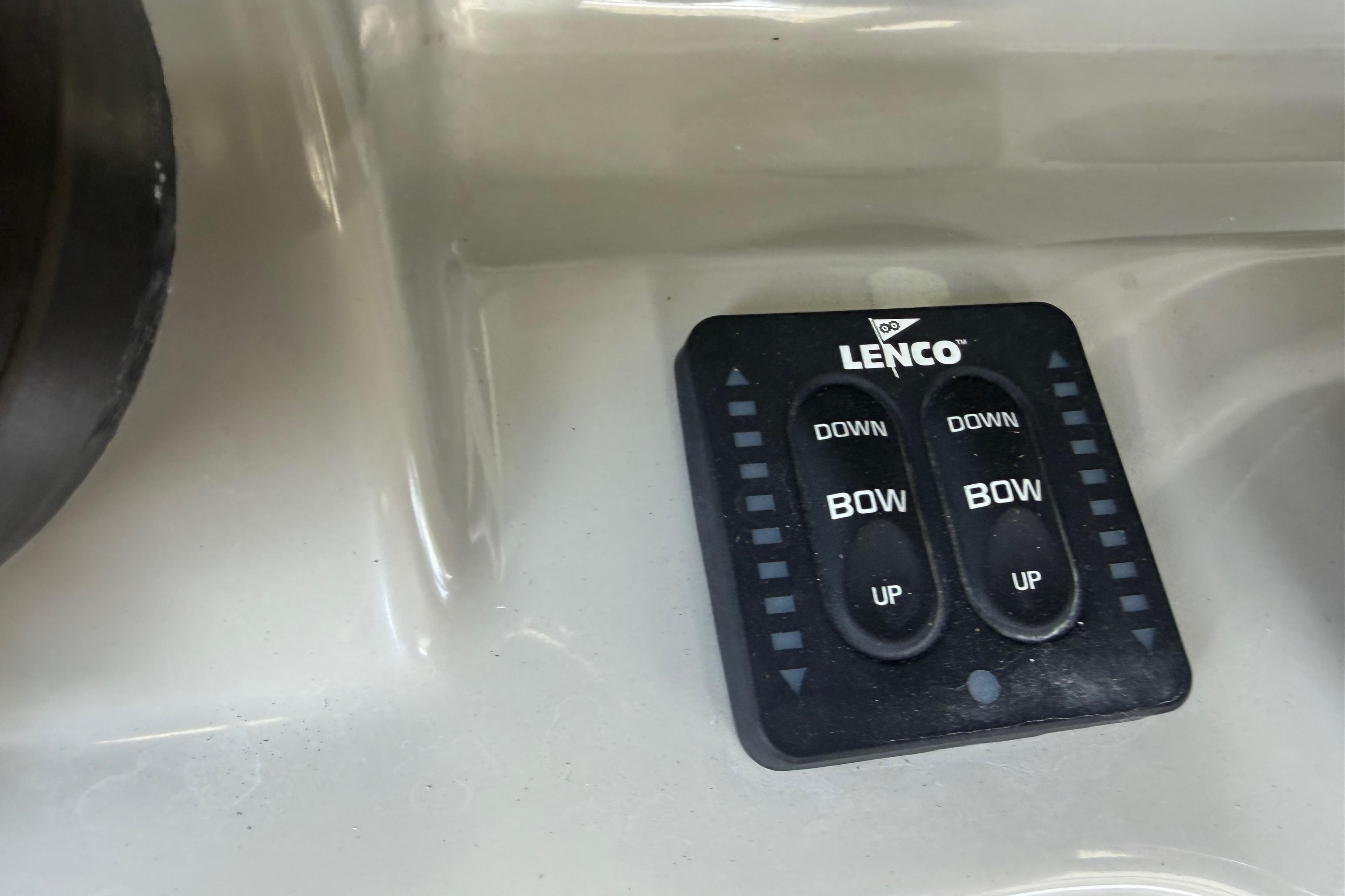 Lenco trim tab controls on a 2016 Boston Whaler 250 Outrage boat dashboard.
