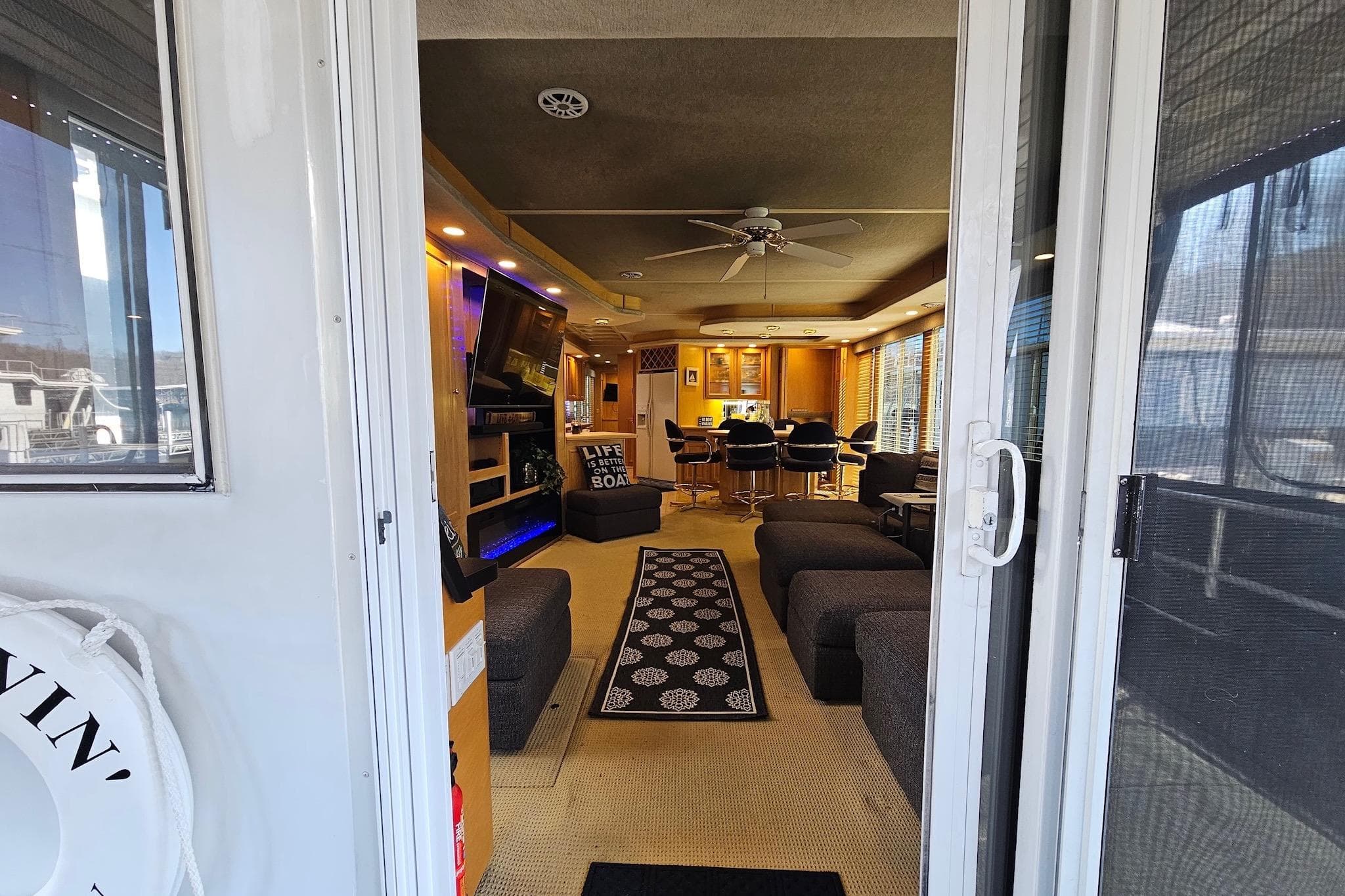 Interior view of a 2001 Sumerset 16x79 houseboat, featuring modern furnishings and decor.