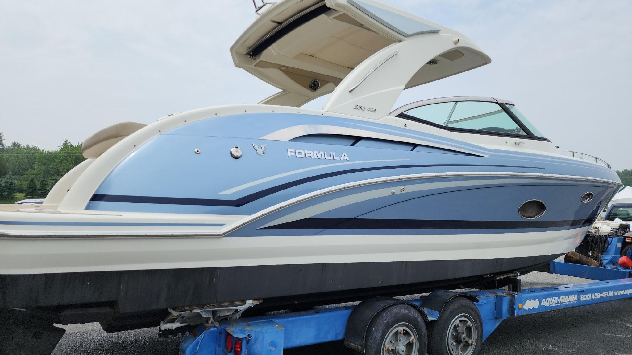 2018 Formula 350 CBR boat on trailer, featuring sleek blue and white design.