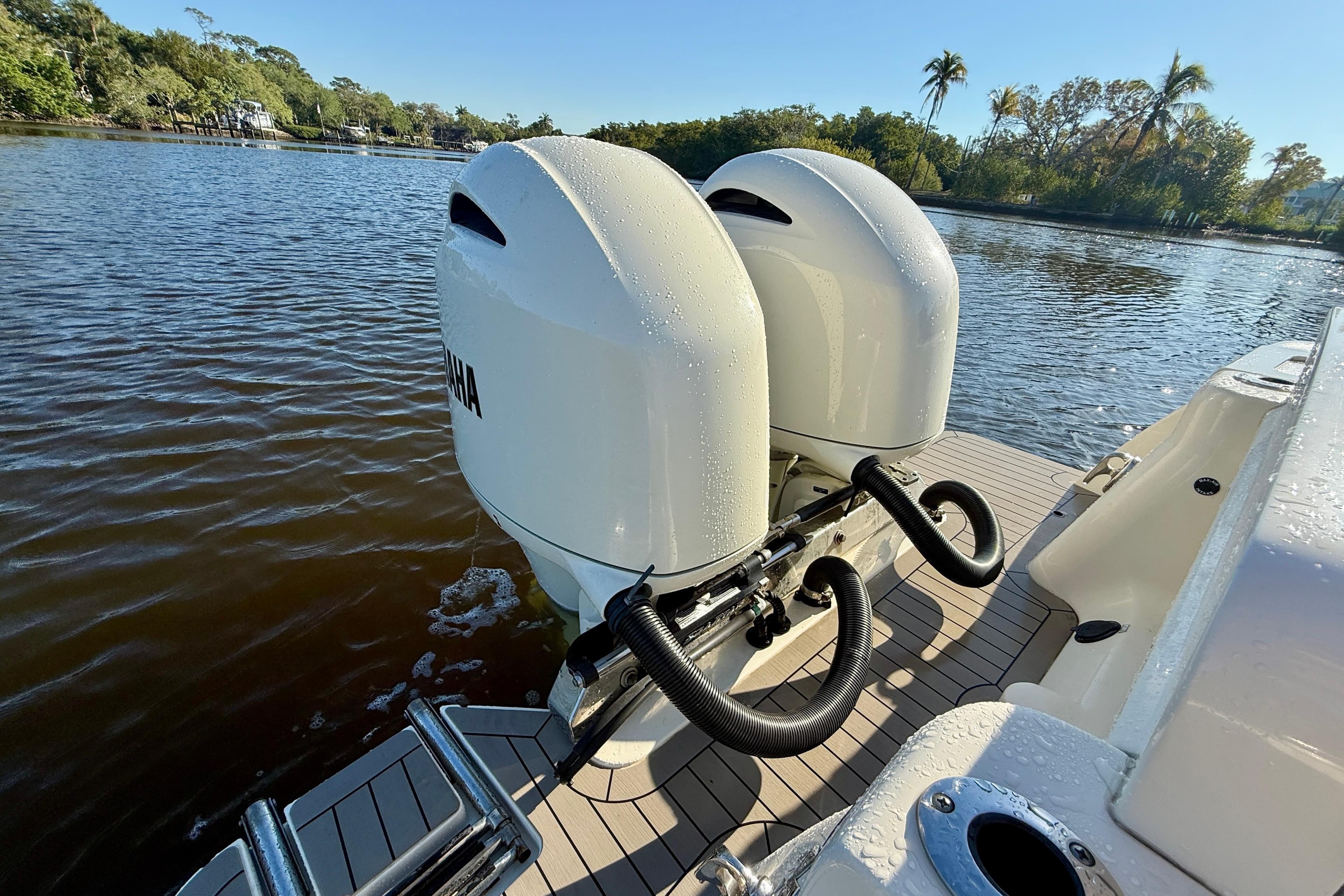 2022 Scout 277 LXF boat with dual outboard motors on a sunny day.