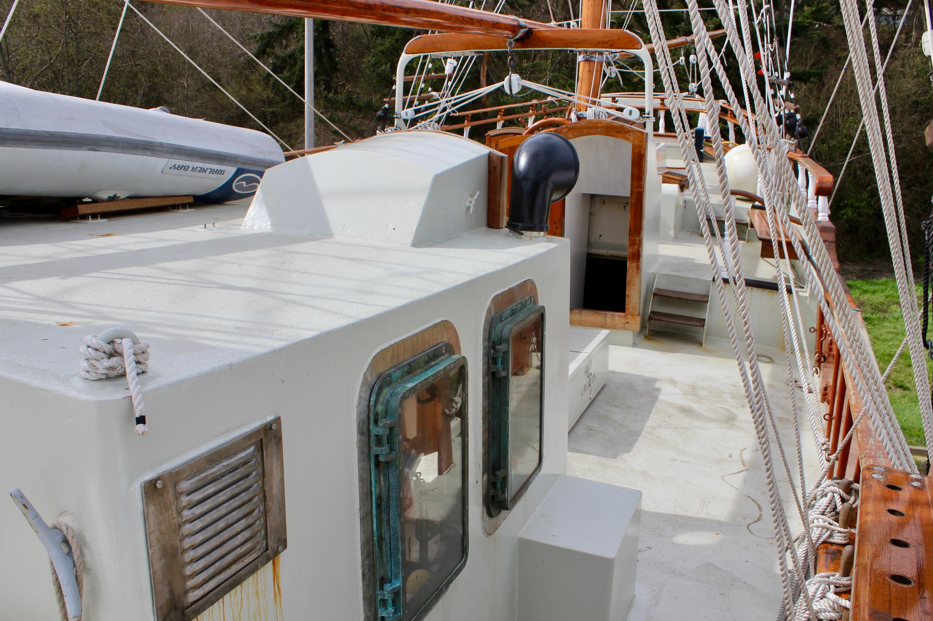 1988 Custom Lahaina Welding Co. Square Topsail Ketch deck with rigging and lifeboat.