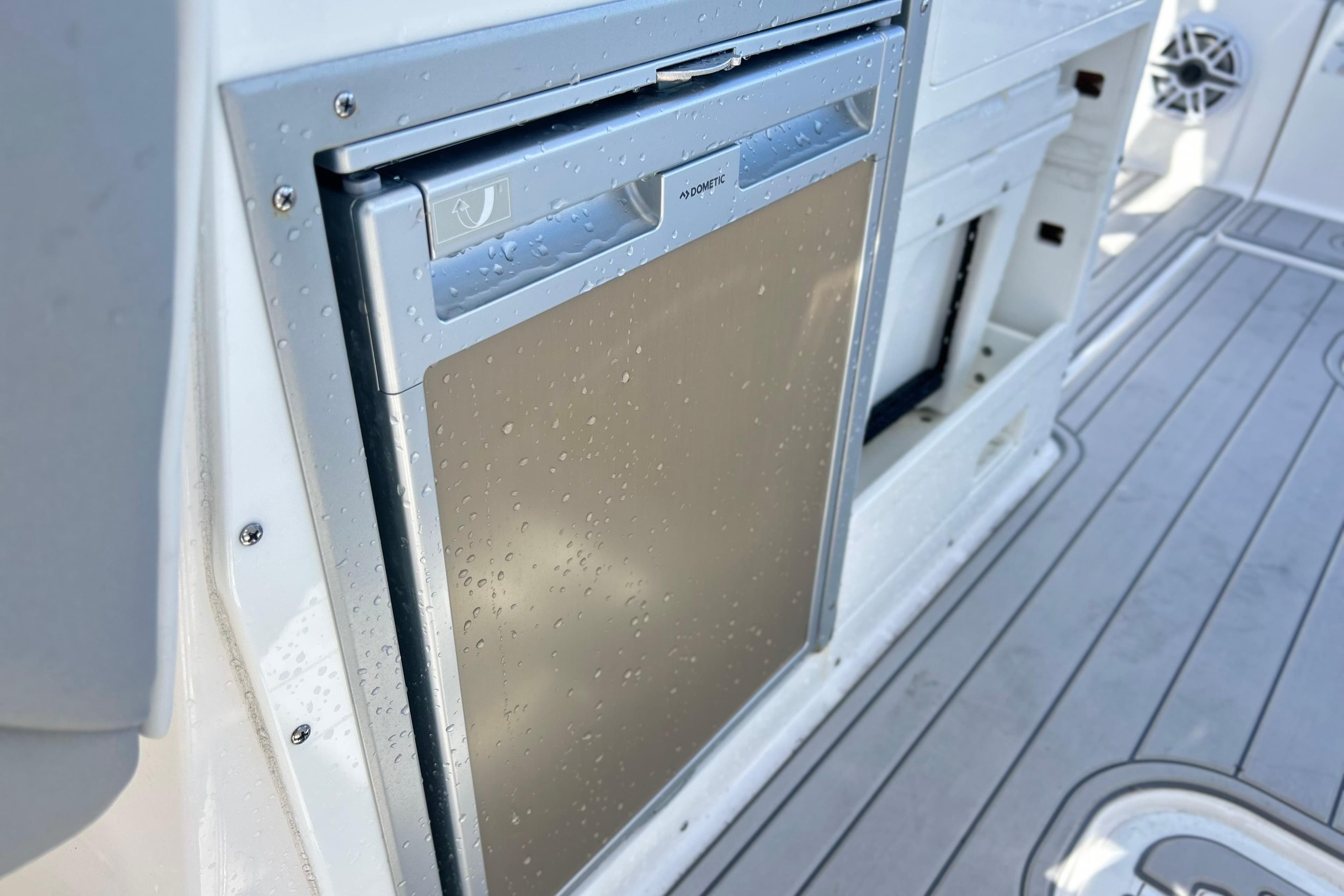 Built-in refrigerator on 2025 Sea Fox 288 Traveler boat, featuring sleek design and water droplets.