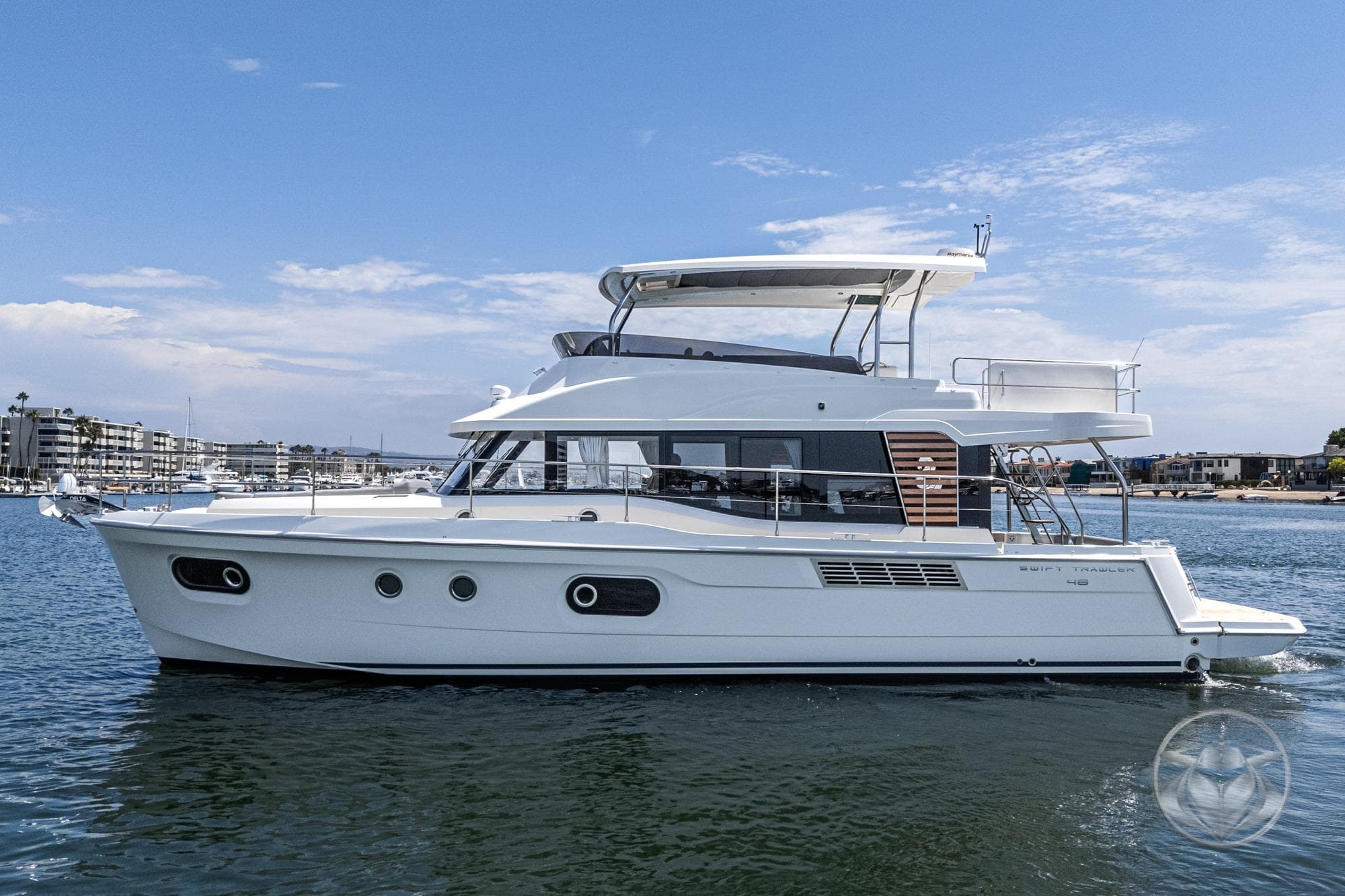 2026 Beneteau Swift Trawler 48 cruising on calm waters under a clear sky.
