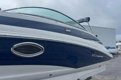 2012 Crownline Eclipse E2 boat with sleek blue and white design, docked outdoors.