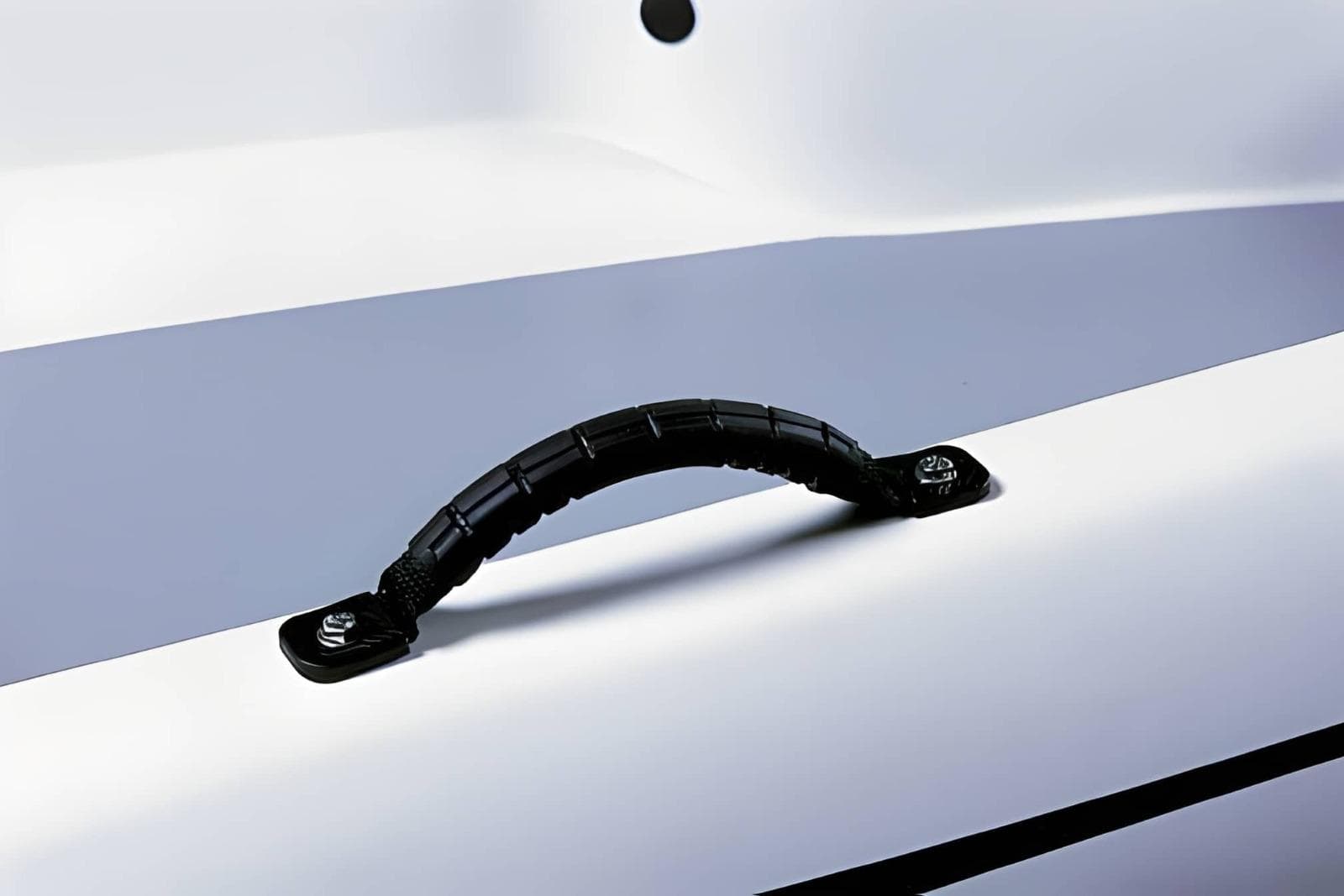 Close-up of a black handle on a 2023 Rigiflex Cap 370 boat.