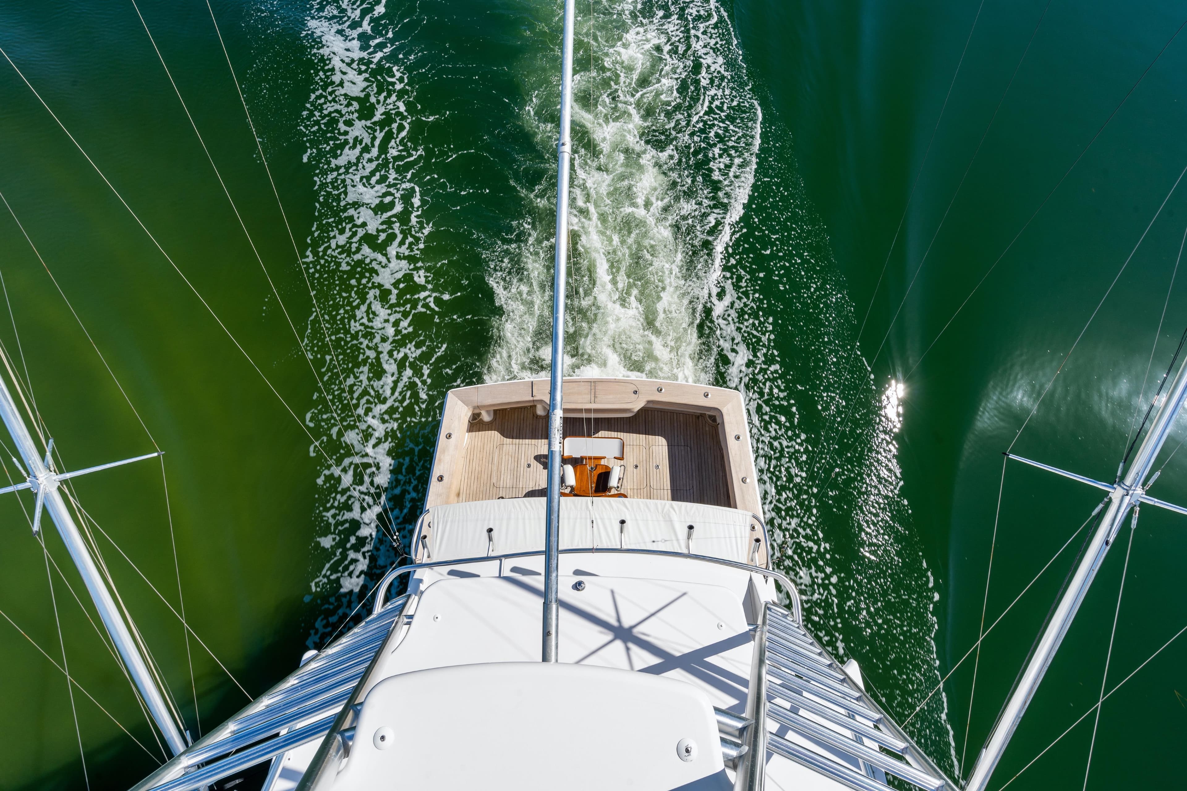 Aerial view of 2007 Viking 56 Convertible yacht cruising on green water.
