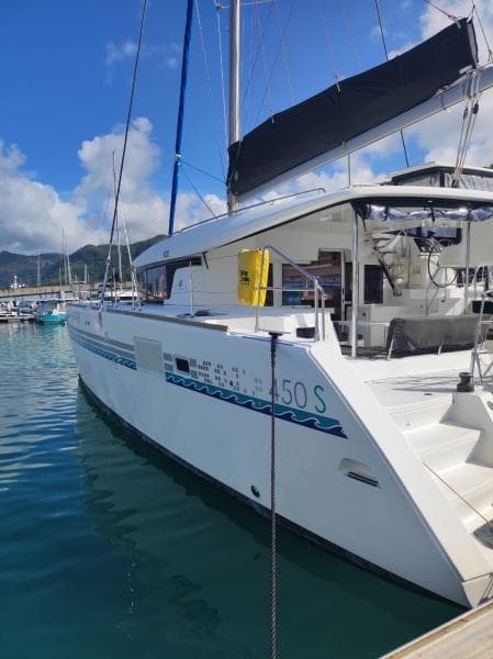 2017 Lagoon 450S catamaran docked at marina, clear sky, calm water.