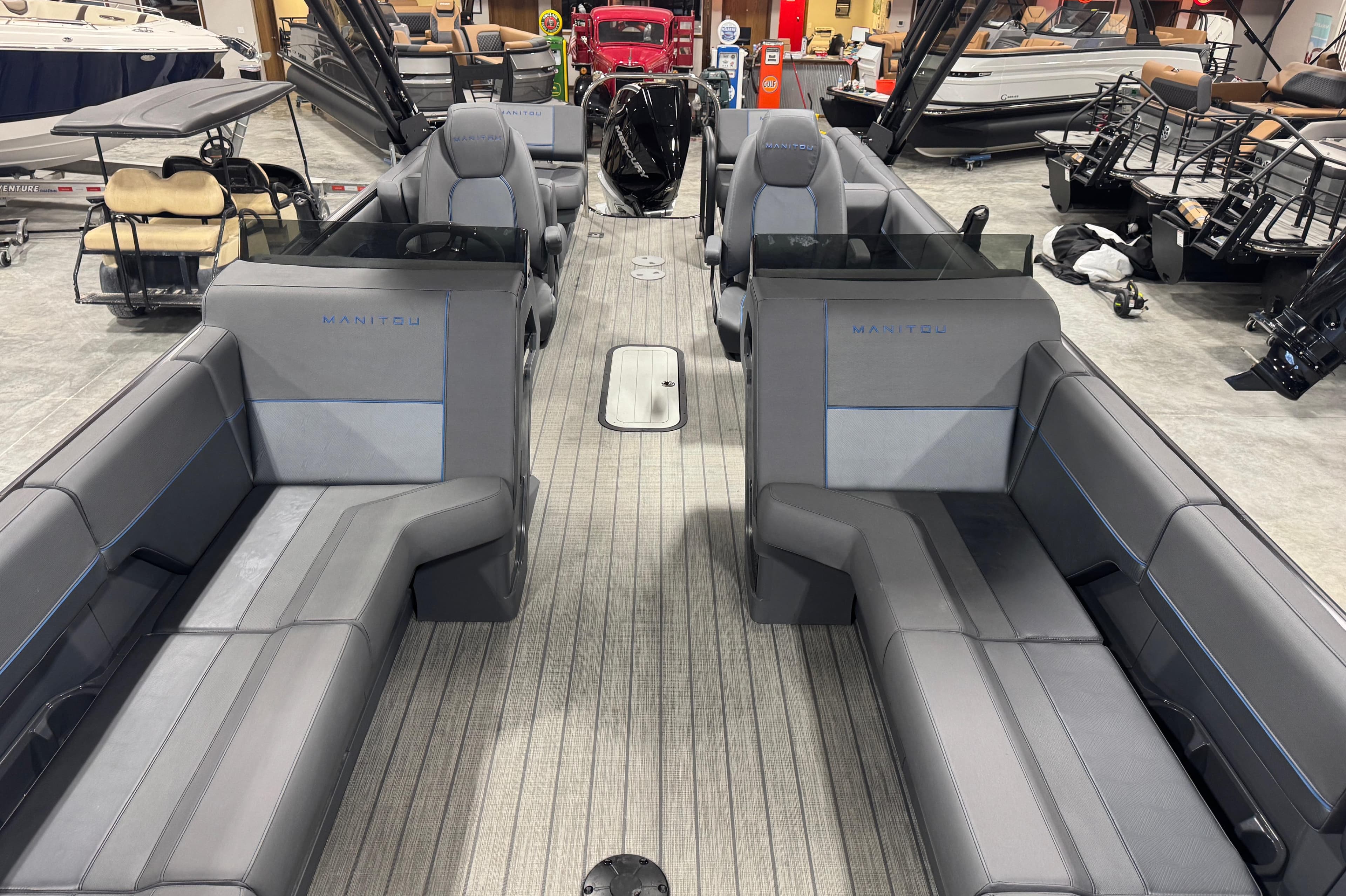 2025 Manitou 24 Explore pontoon boat interior with sleek gray seating and modern design.