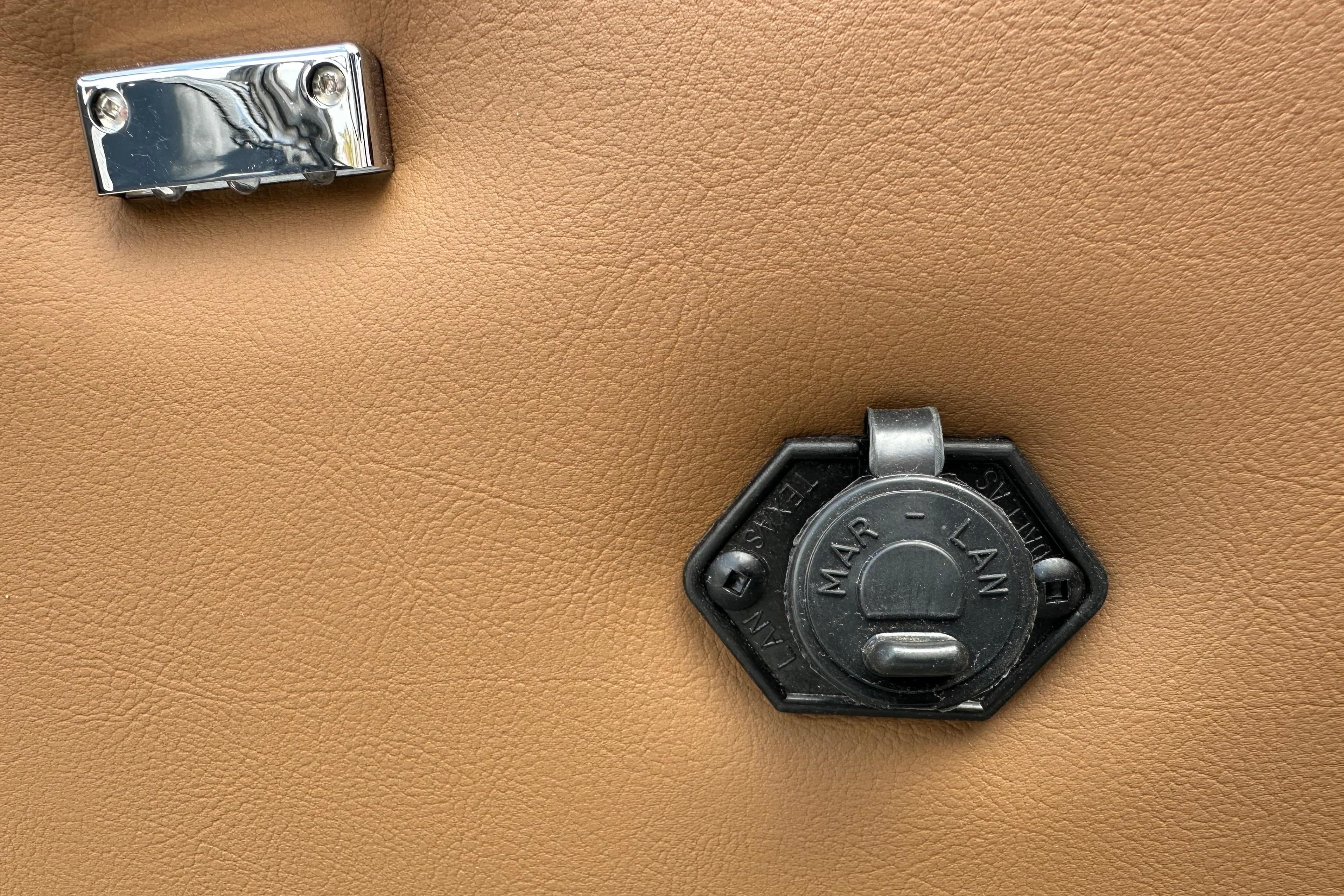 2026 Ranger Reata 223FC interior detail with metal latch on tan surface.