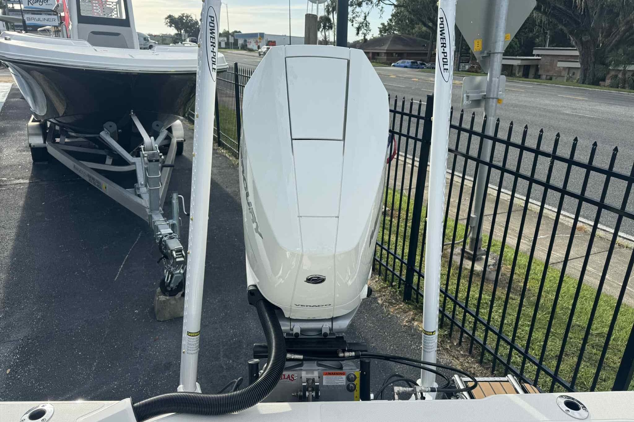 2026 Ranger 2510 Bay boat with Mercury engine and Power-Pole anchors, parked on a trailer.