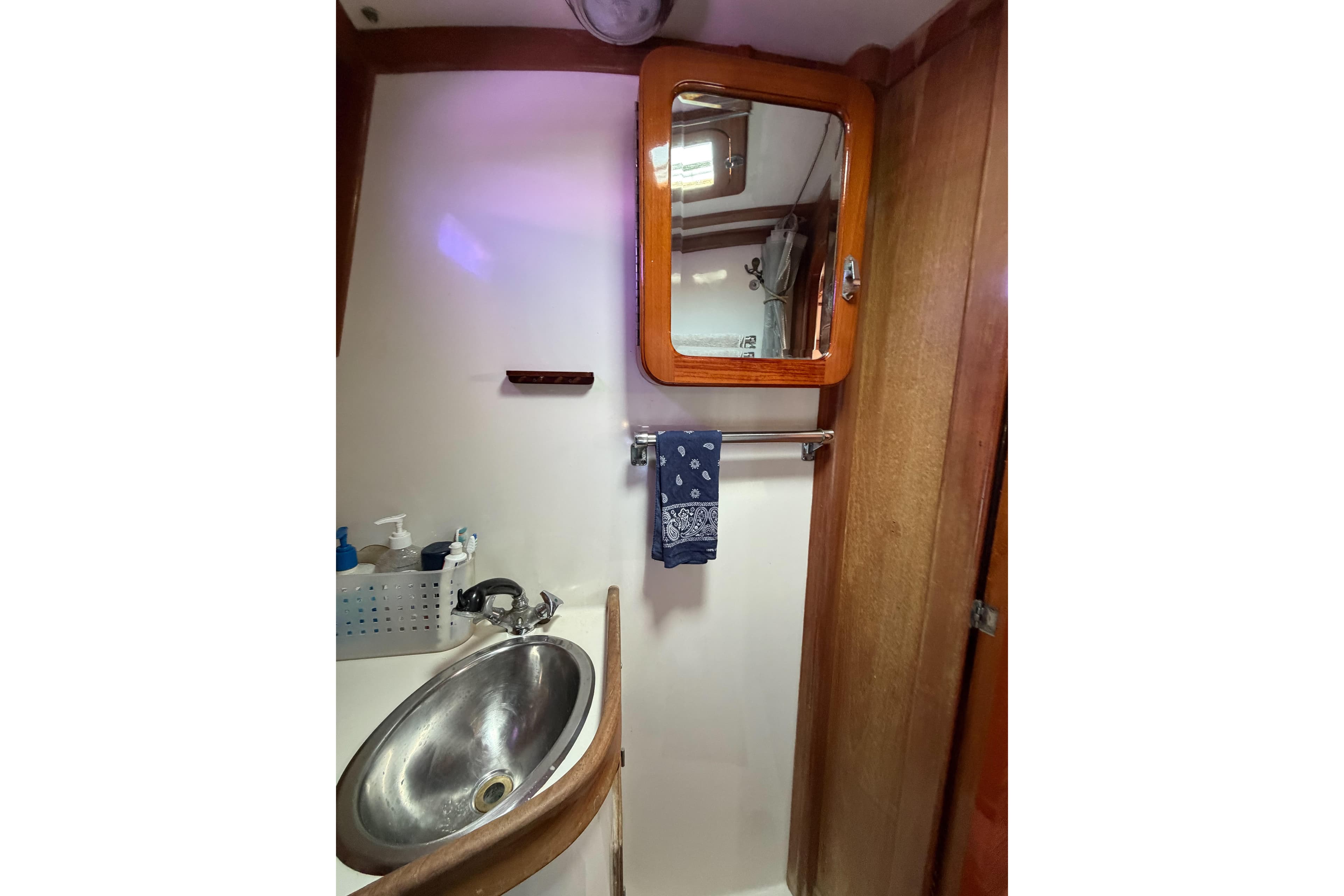 1989 Cabo Rico 34 yacht bathroom with sink, mirror, and towel rack.