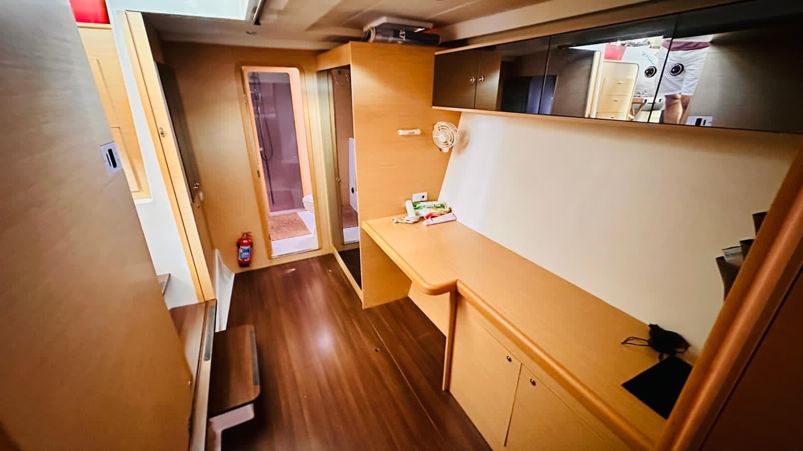 Interior of 2011 Lagoon 400 yacht, featuring wooden flooring and modern cabinetry.