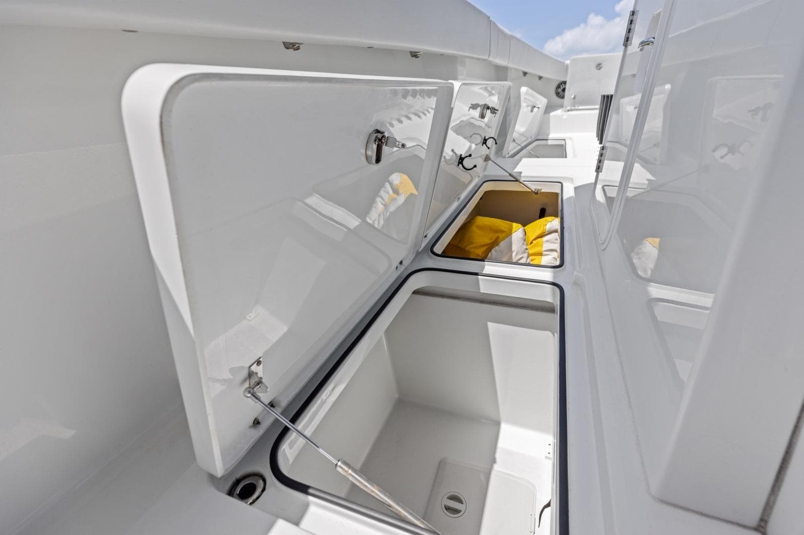 Open storage compartments on a 2020 Freeman 42LR boat deck.