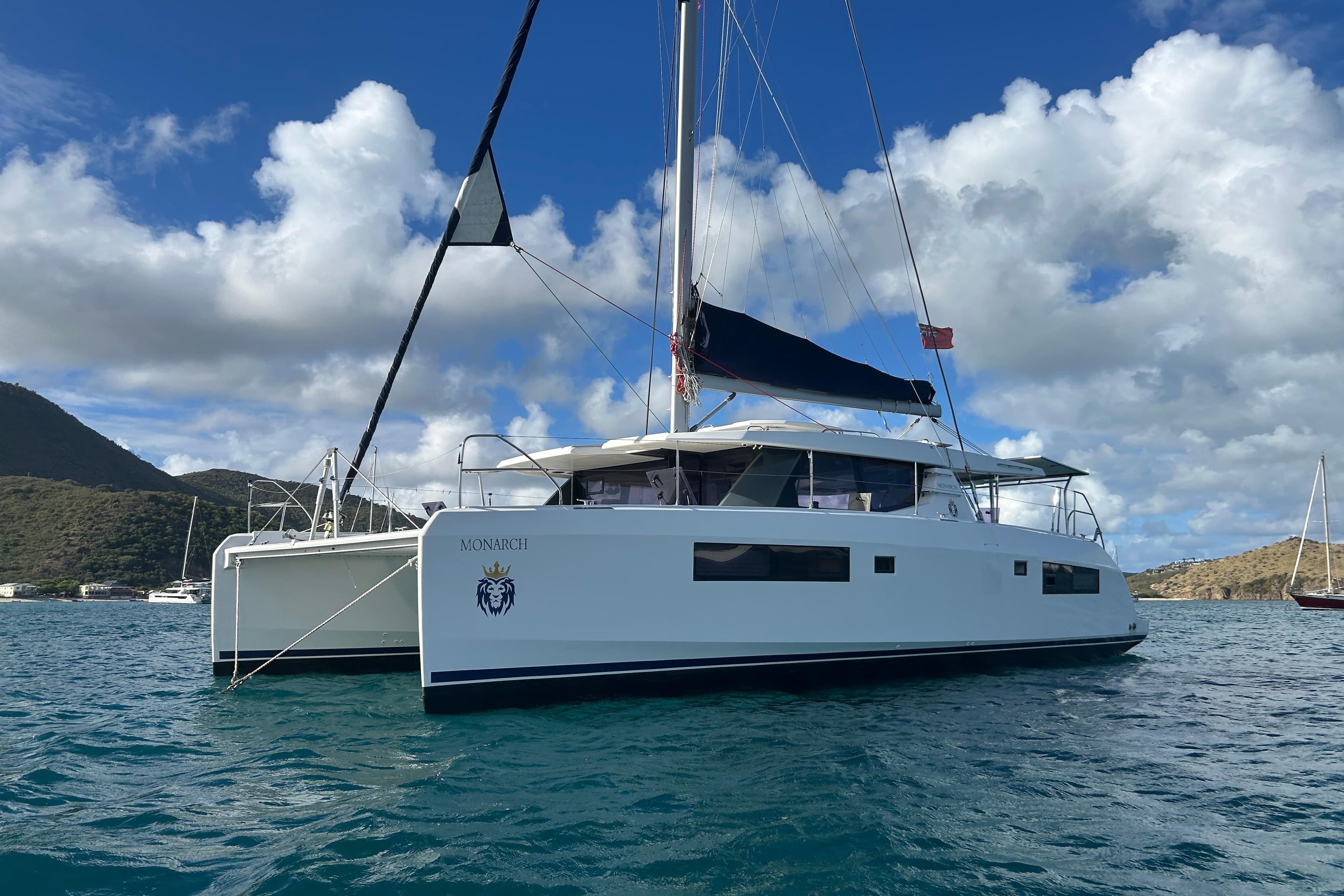 2020 Leopard 45 catamaran sailing on blue waters under a partly cloudy sky.