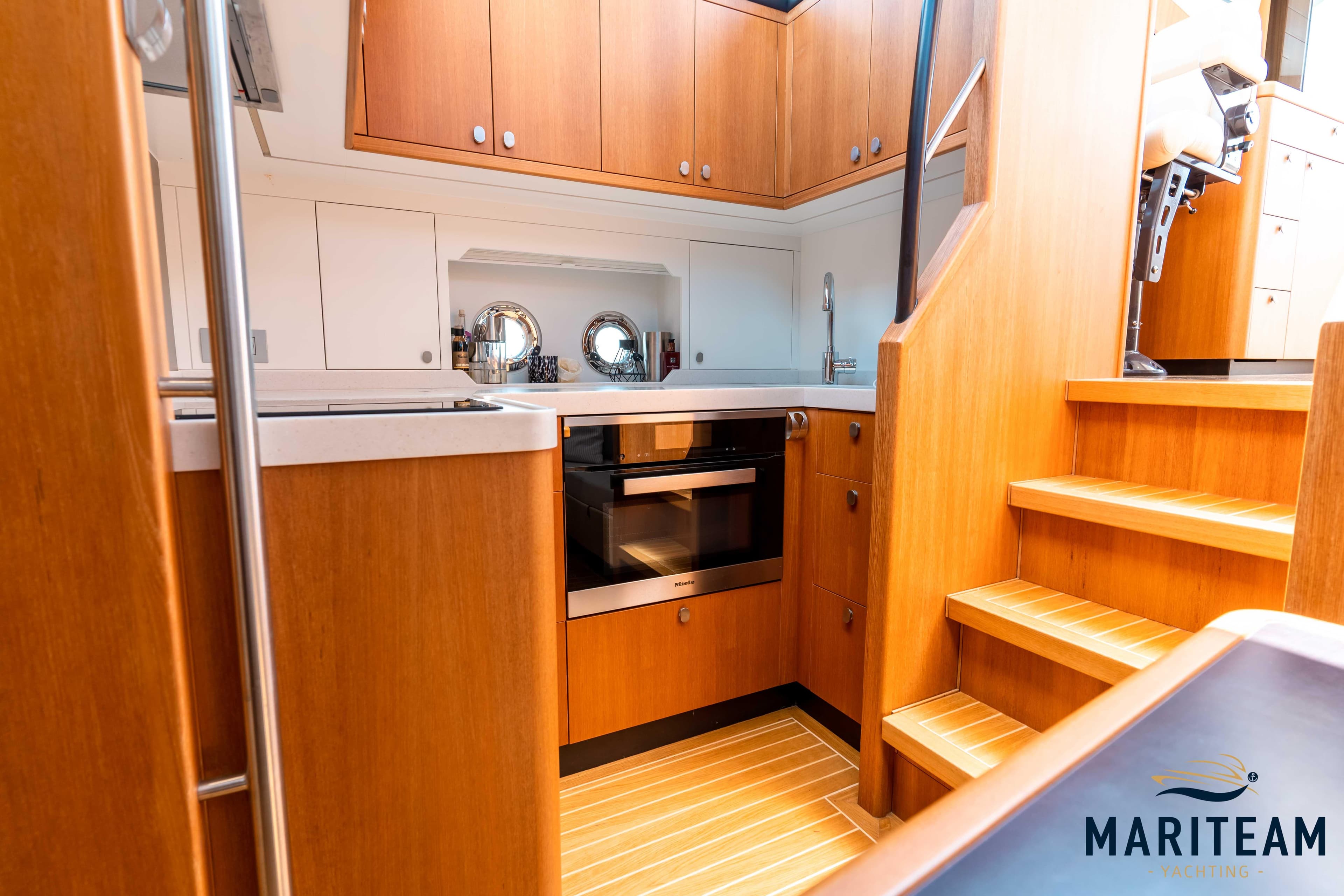 Interior of 2017 Breedendam MTB fourzero Wheelhouse with wooden cabinetry and stairs.