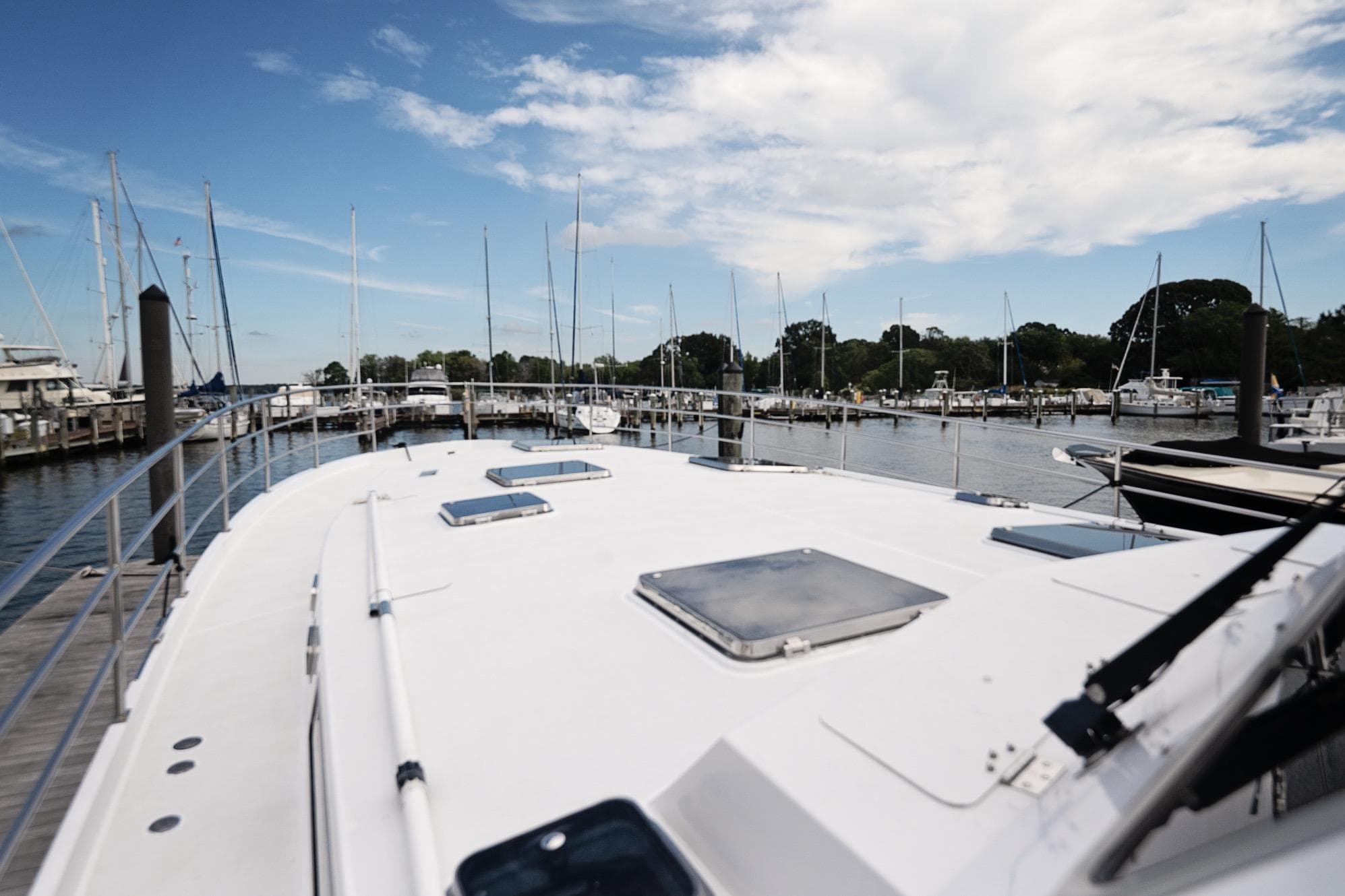 2007 Pilot Cruiser Expedition yacht docked at a marina under a blue sky.