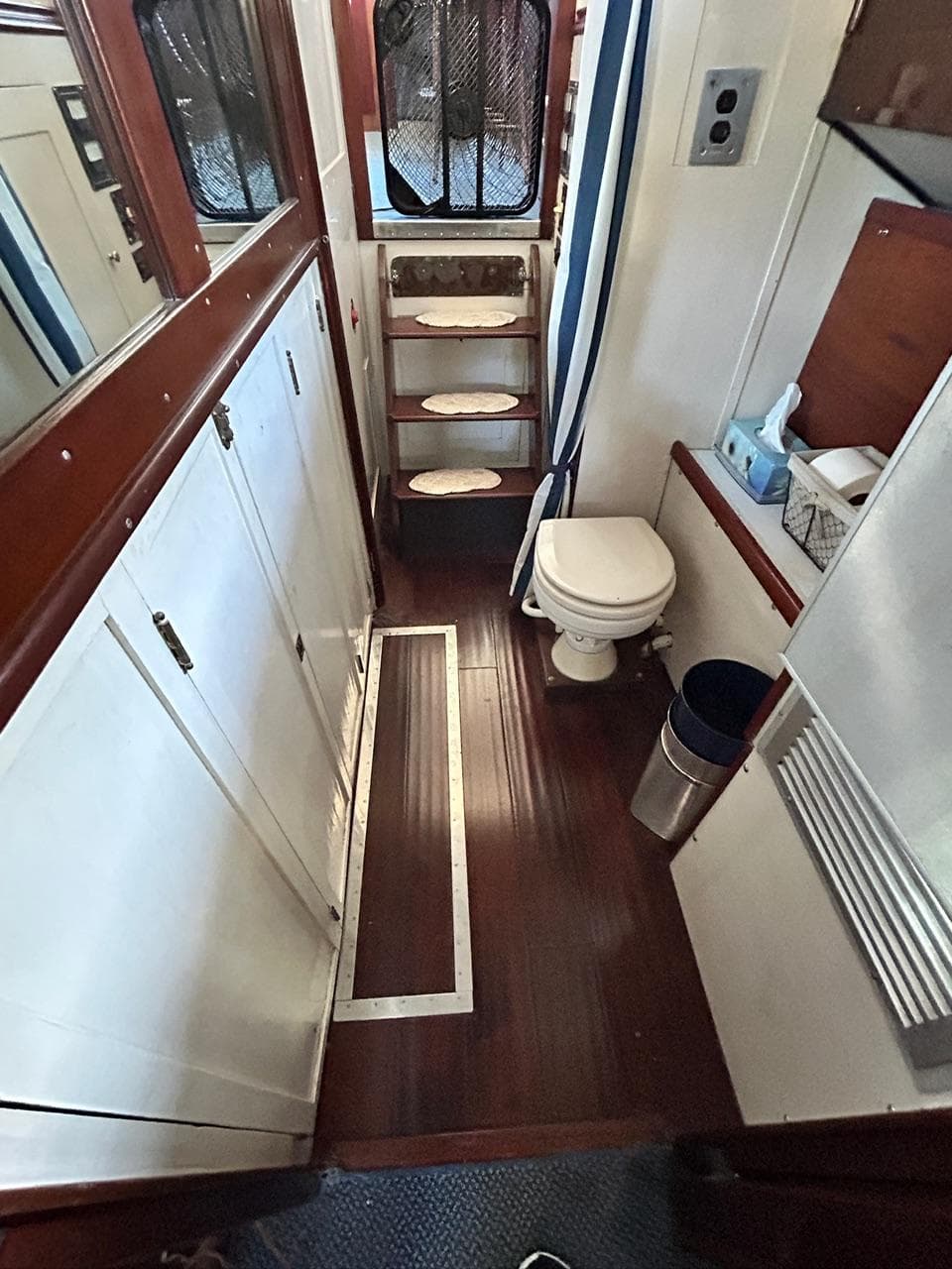 Interior of 1930 Classic ACF 47' Motor Yacht with wooden flooring and compact bathroom.