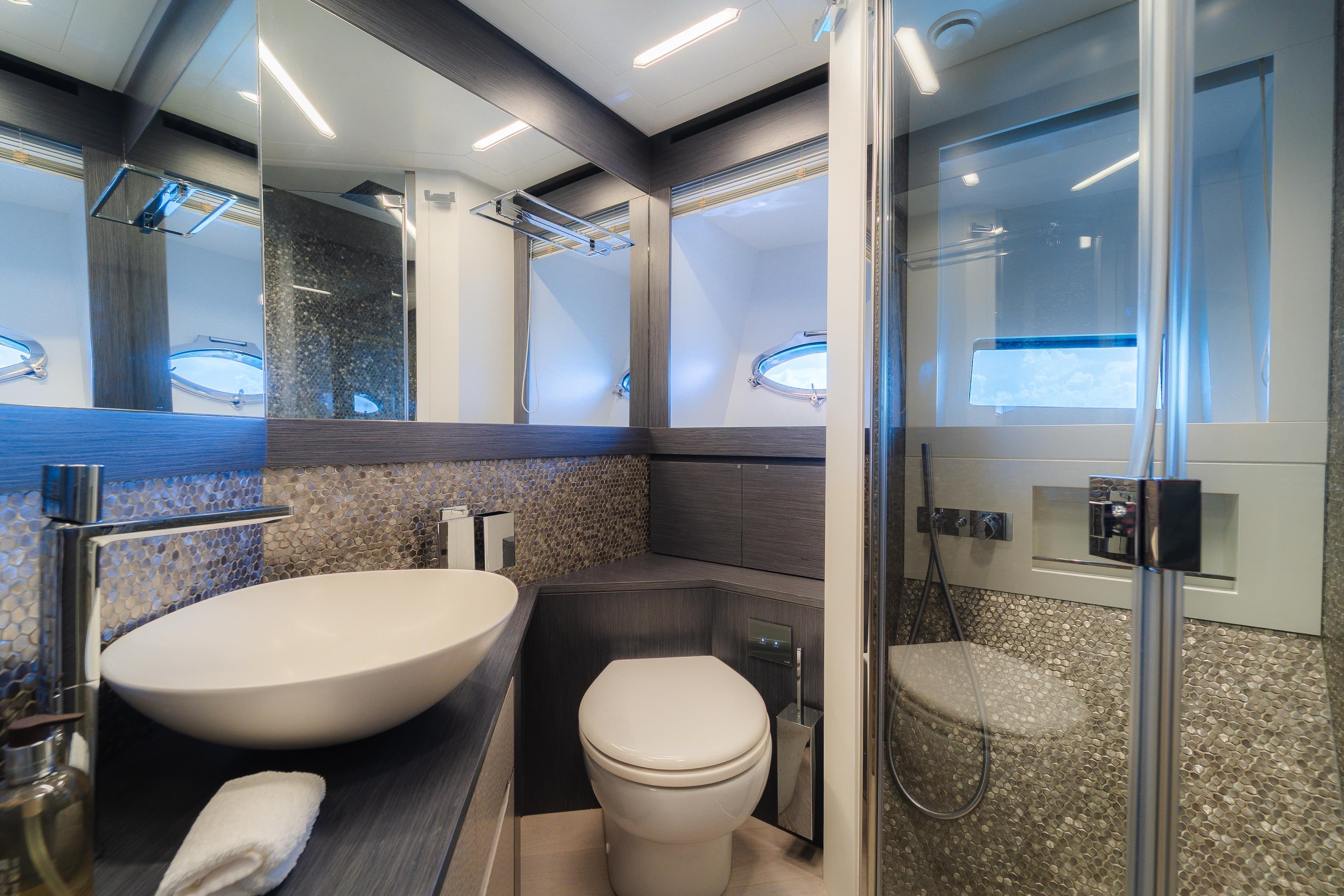 Luxurious bathroom in 2021 Pershing 8X yacht with modern fixtures and elegant design.