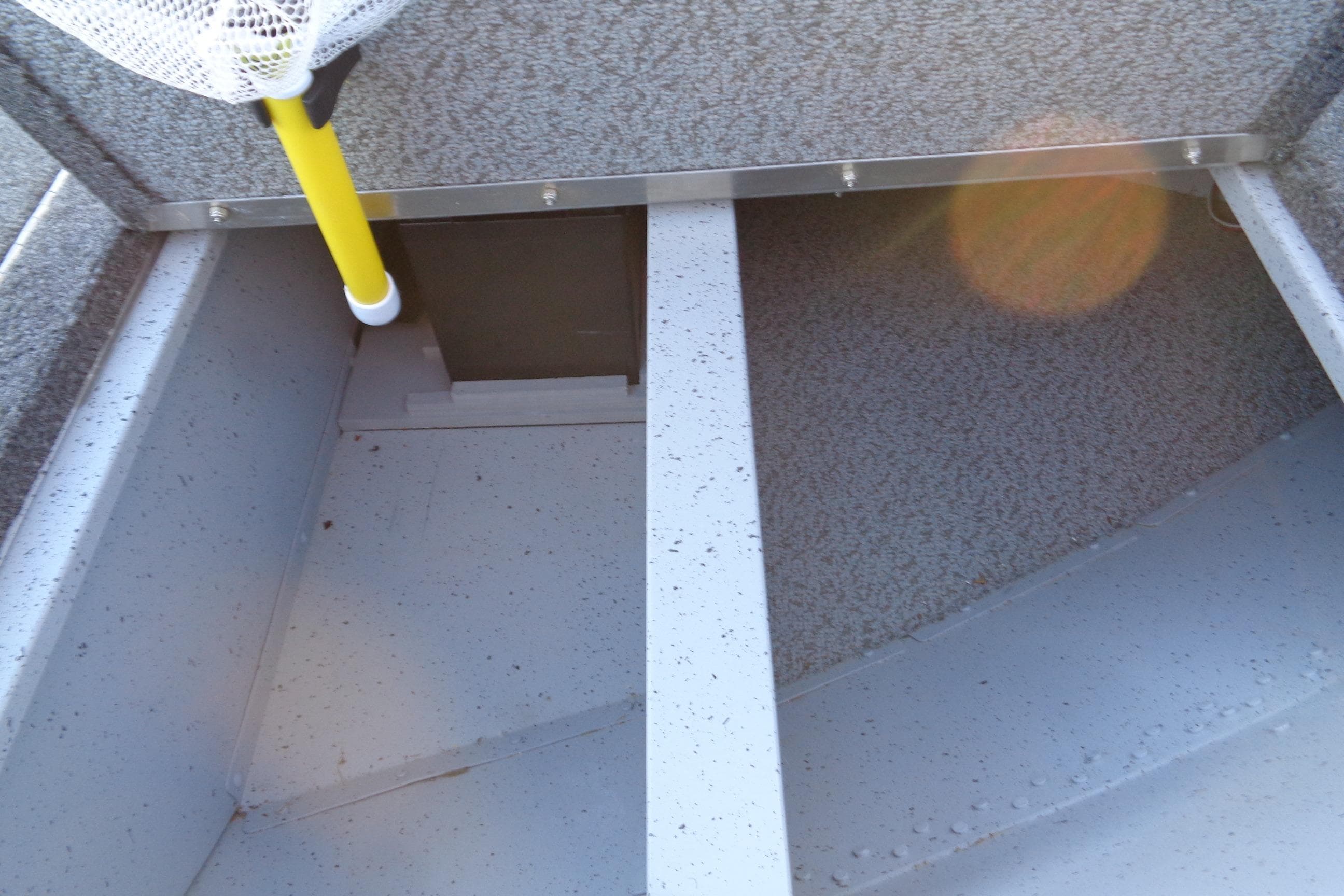 2024 Lund 1400 Fury Tiller interior storage compartment with fishing net.